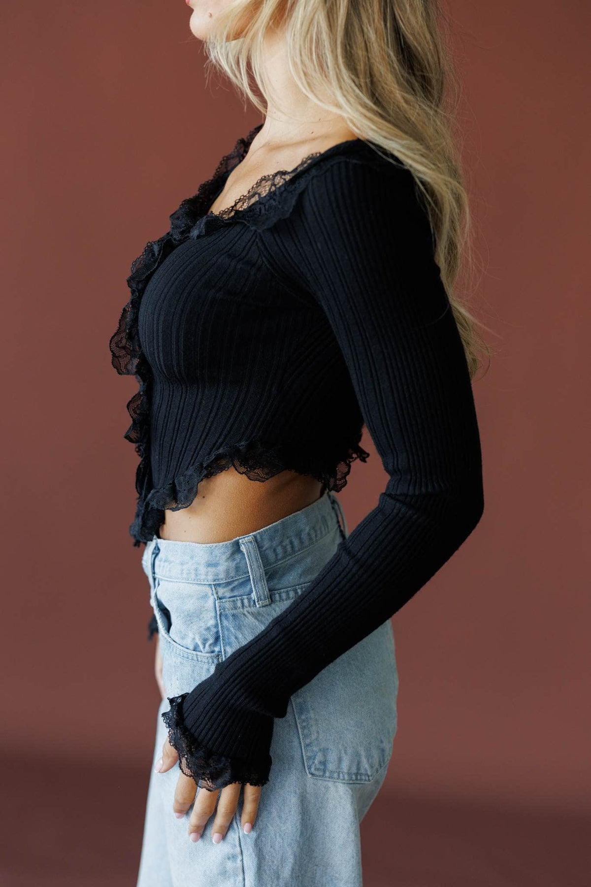 Colette Ruffle Top in black, side view showing the ruffle cuff