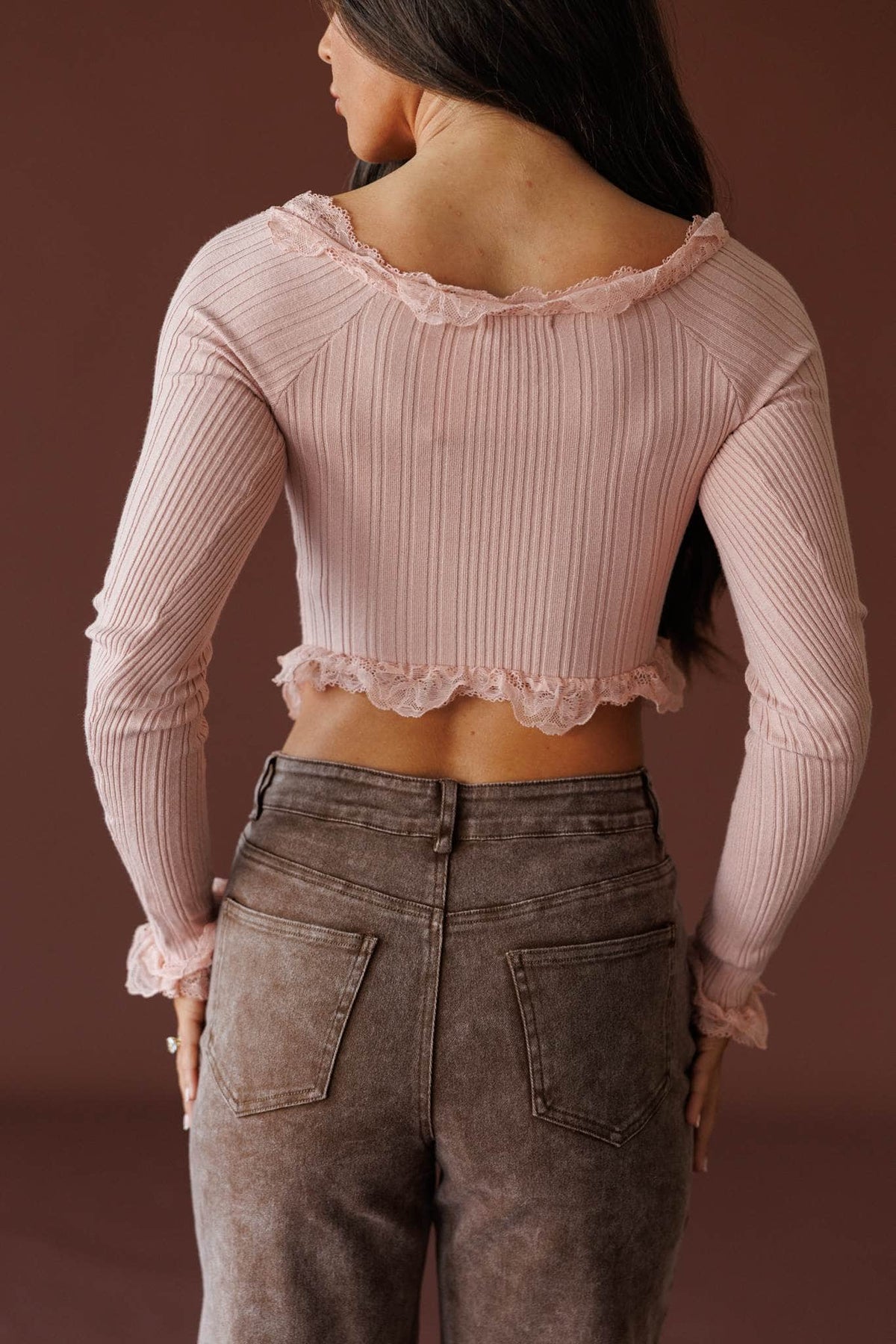 Colette Ruffle Top in misty rose, back view showing the ribbed knit and ruffle hem