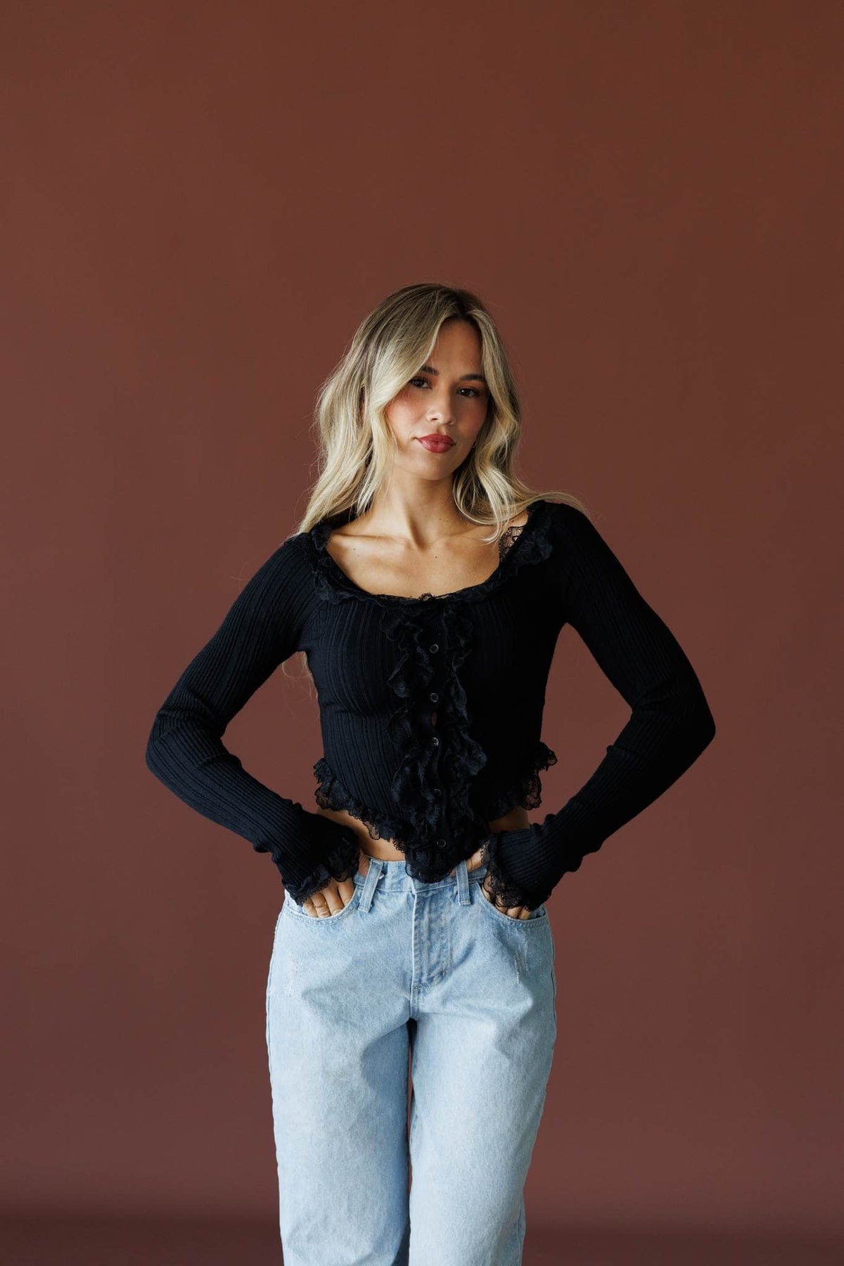 Colette Ruffle Top in black, front view on model with light wash jeans