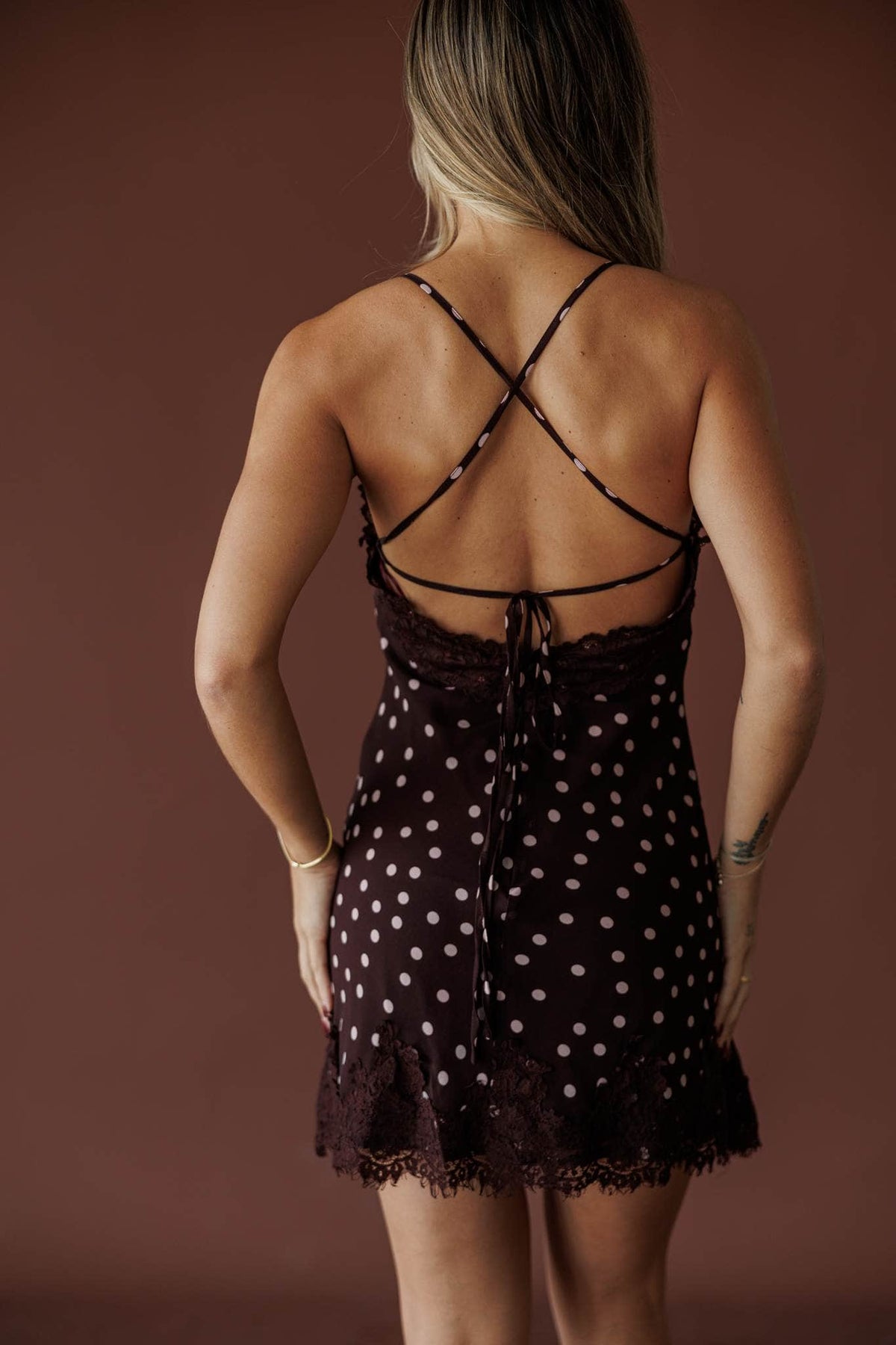 Plum Dot Lace Mini Dress, in fairly plum, back view of the crossed straps