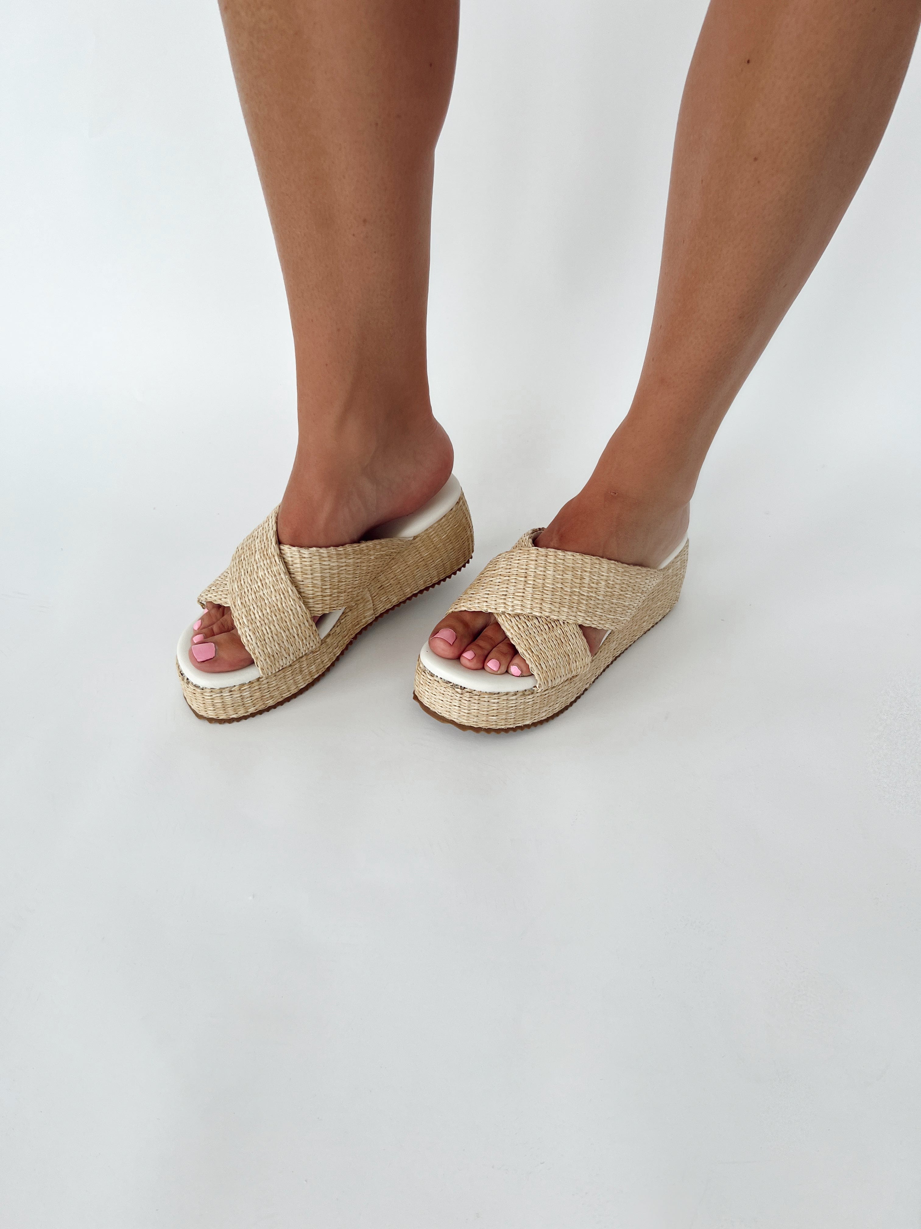 woman modeling woven platform sandals