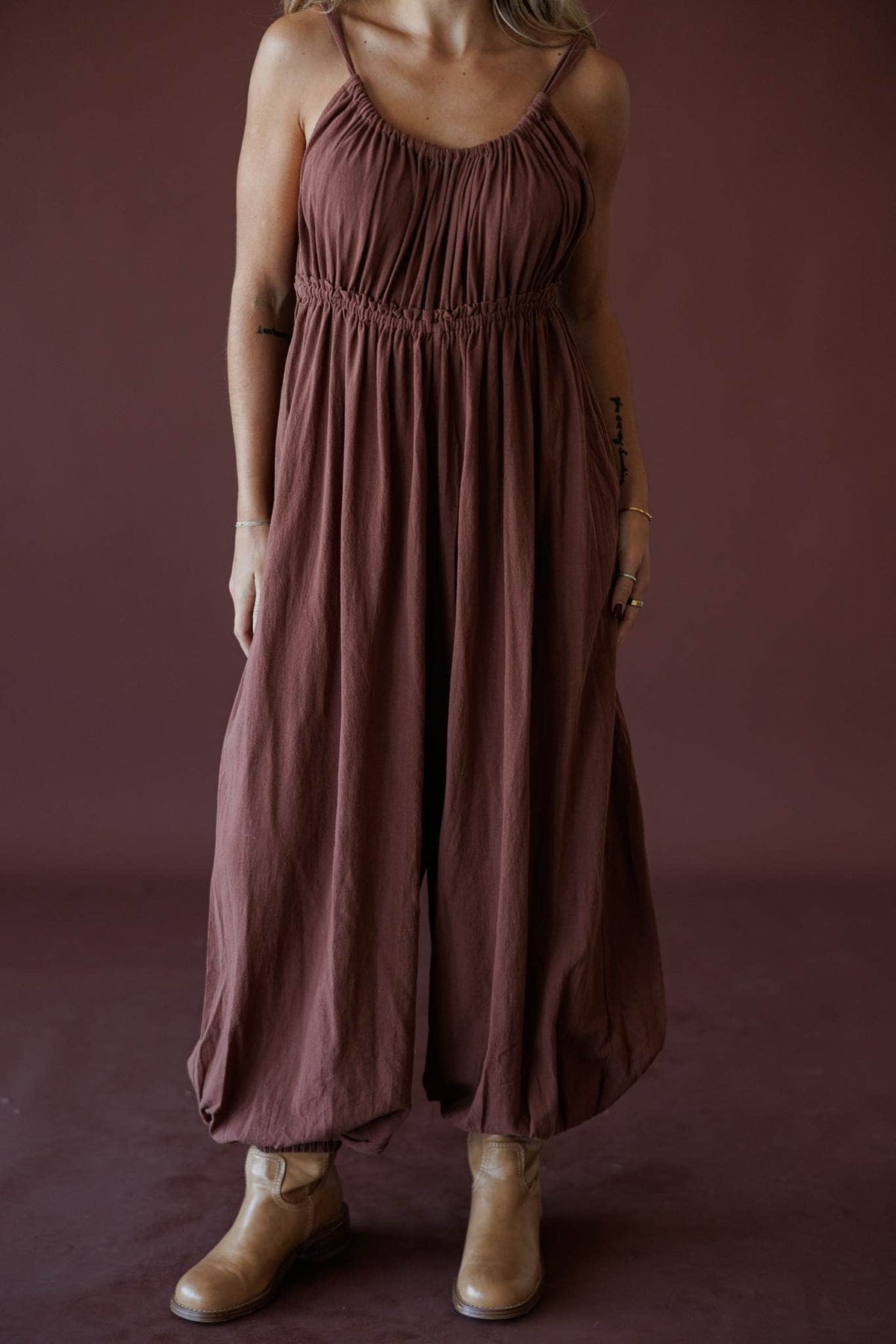 The Roam Jumpsuit, in brown, close front view of the adjustable straps