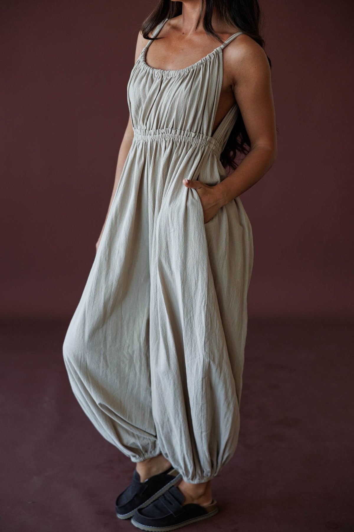 The Roam Jumpsuit, in sand, three-quarter view with side pockets
