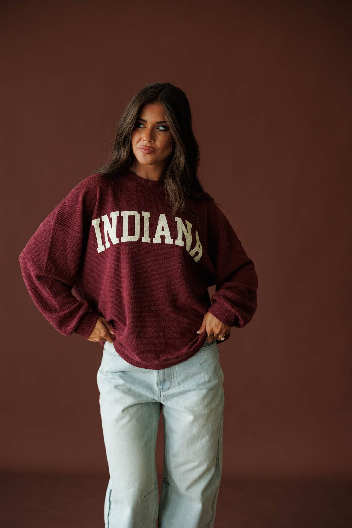 Indiana Cloud Knit Sweatshirt in wine, full-length view with light wash jeans