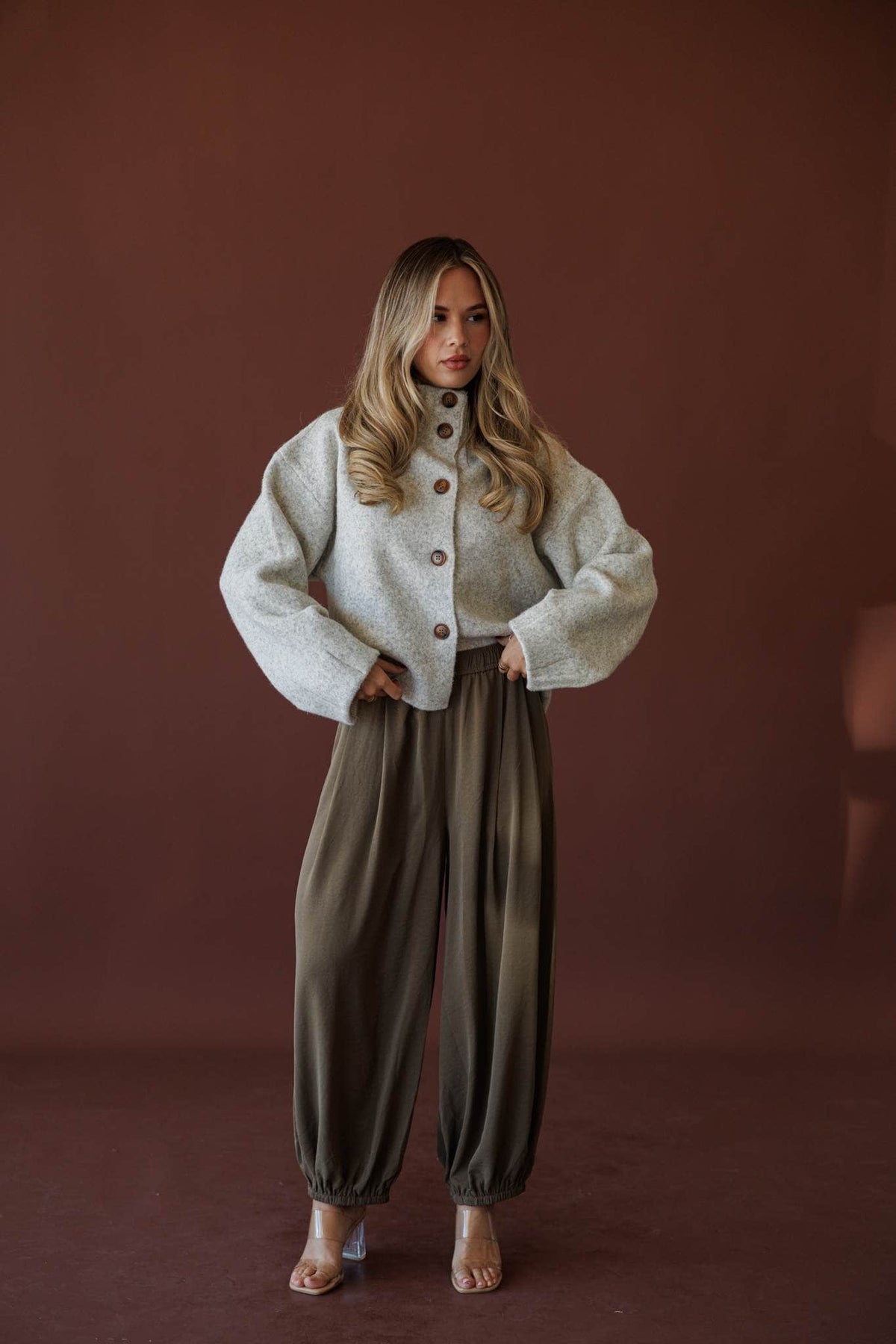 Olive Press Satin Pants, in khaki, full-length front view with a cream jacket