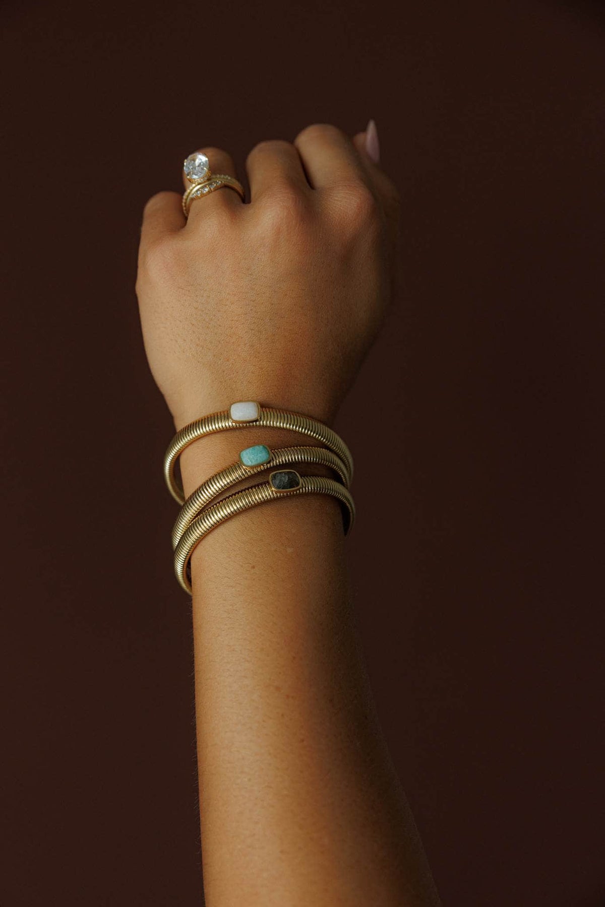Gem Accent Bangle, ivory, light green and coffee worn on the wrist