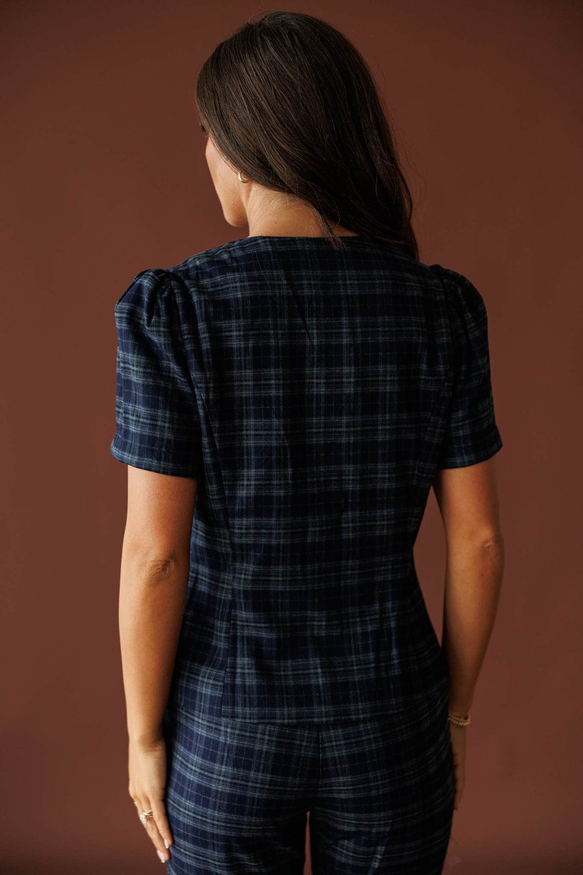 The Socialite Top in teal plaid, back view showing the short sleeves