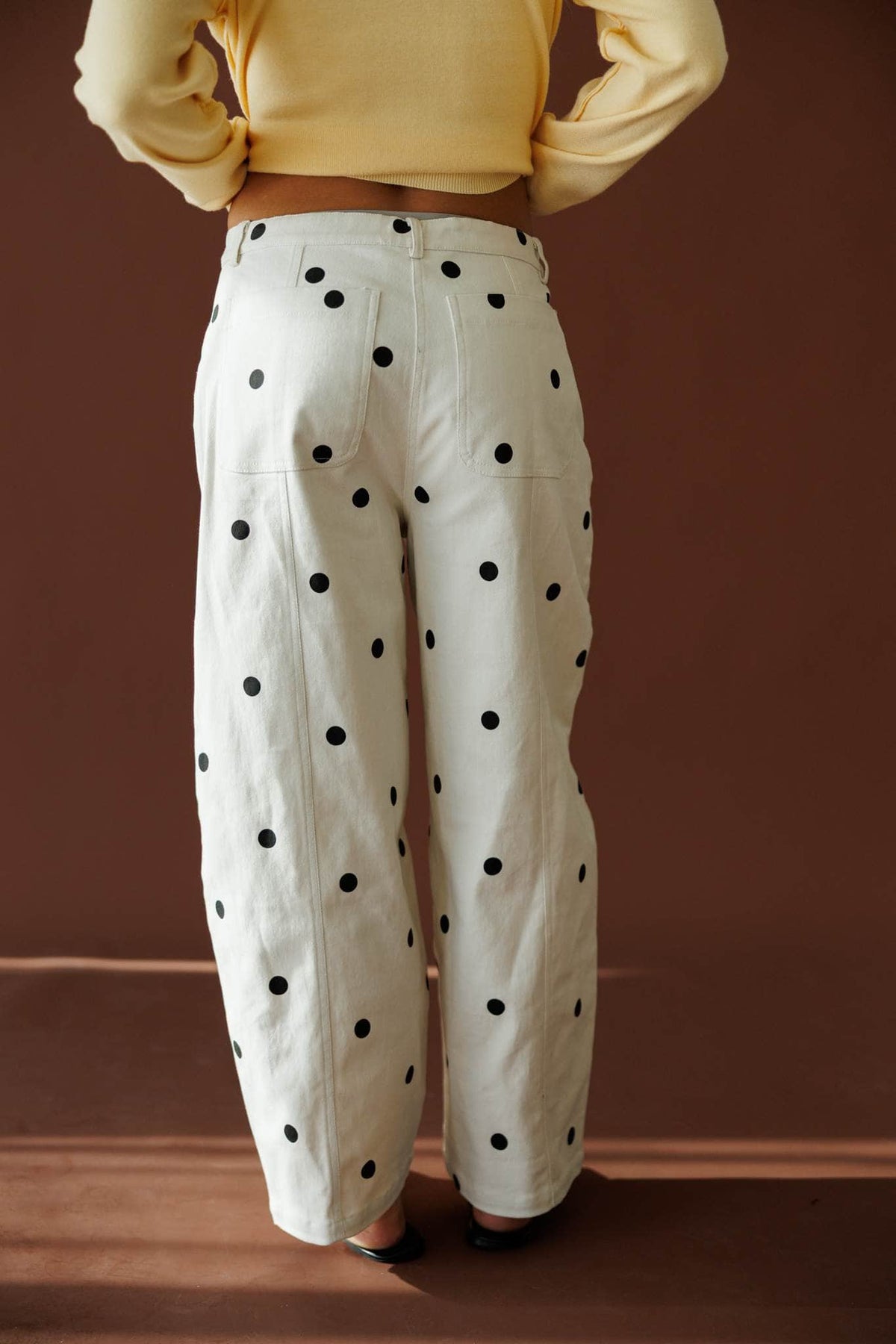 On The Dot Barrel Pants in cream and black dot, back view showing the pockets and barrel leg