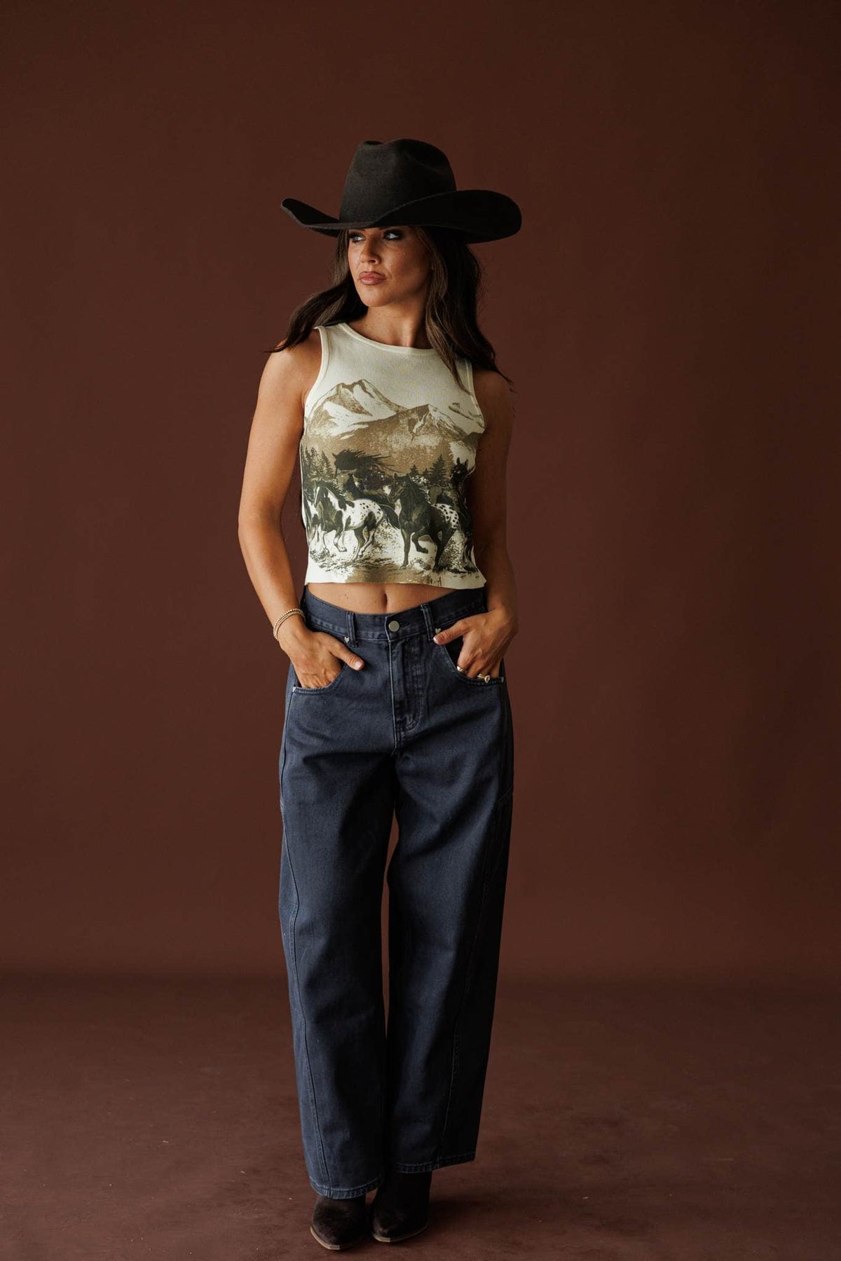 Midnight Barrel Jeans in black, full-length view on model with a black hat