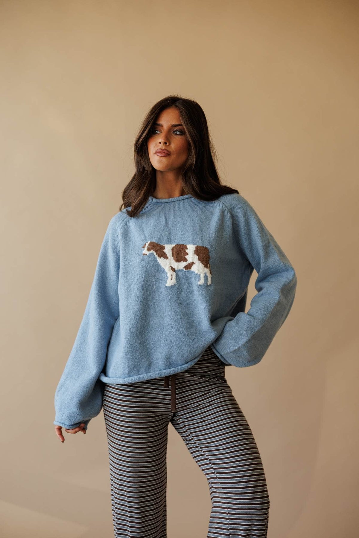 Dusty blue sweatshirt with cow graphic, front view