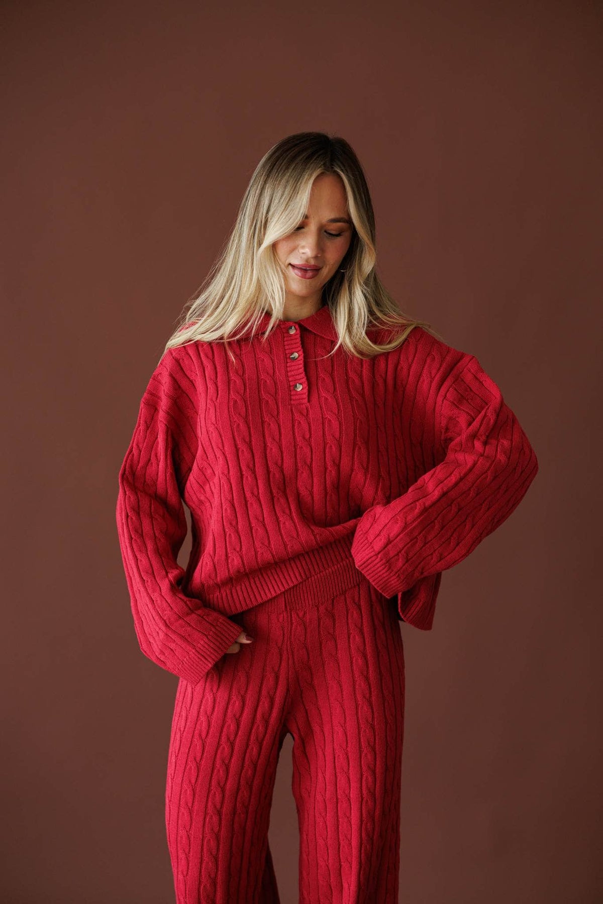 Cherry Cable Knit Sweater in red, front close-up of the collar and quarter button placket