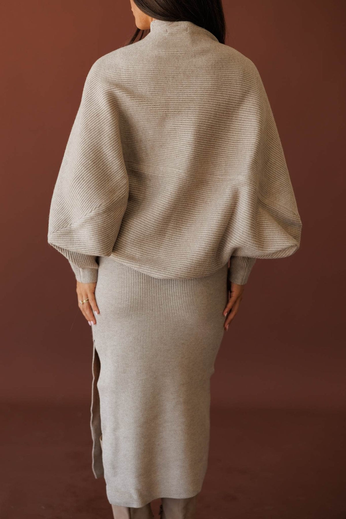 Serving Looks Shrug, in cloud grey, back view of the draped sleeves