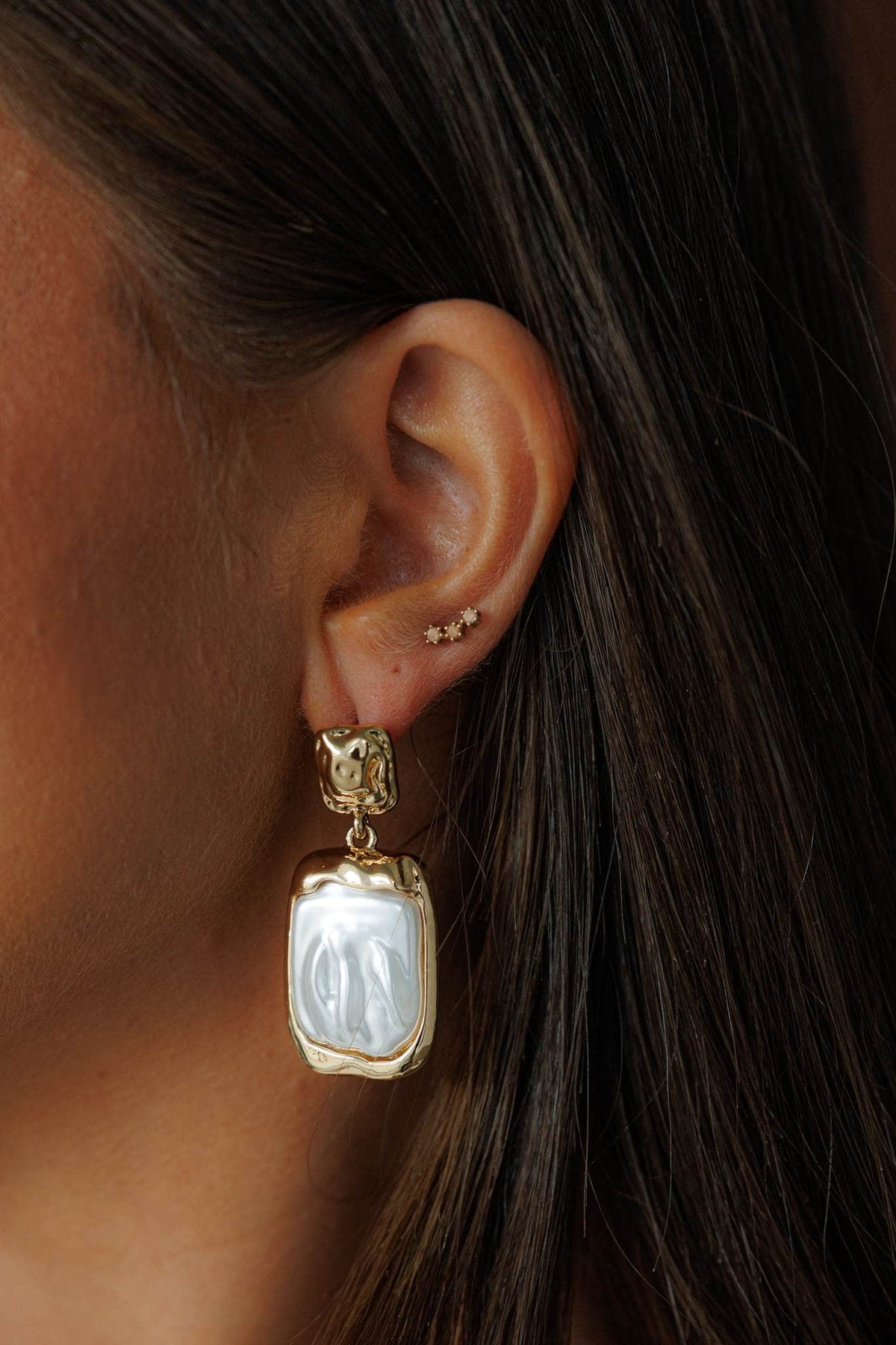 Gold Sculpted Drop Earrings, worn on the ear