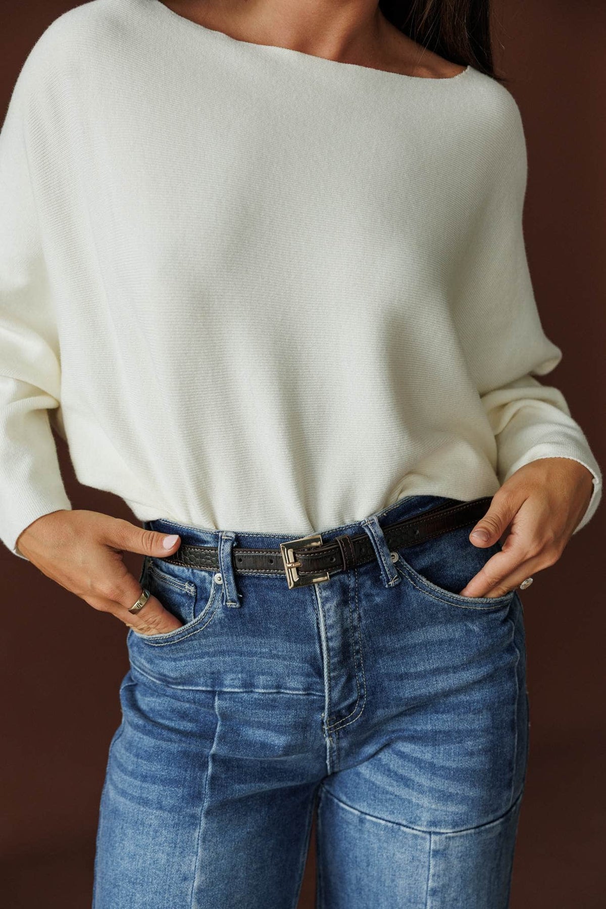 Jordan Belt, in black shine, close front view of the belt with hands in pockets