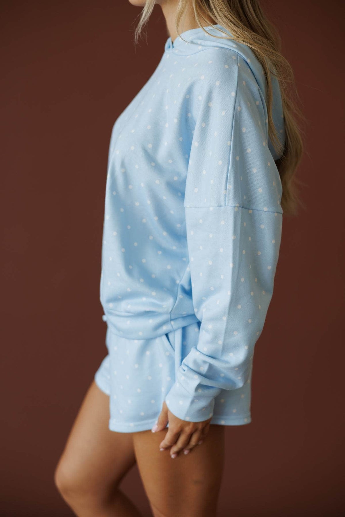 Baby Blue Polkadot Hoodie in baby blue, side view showing the relaxed terry hoodie