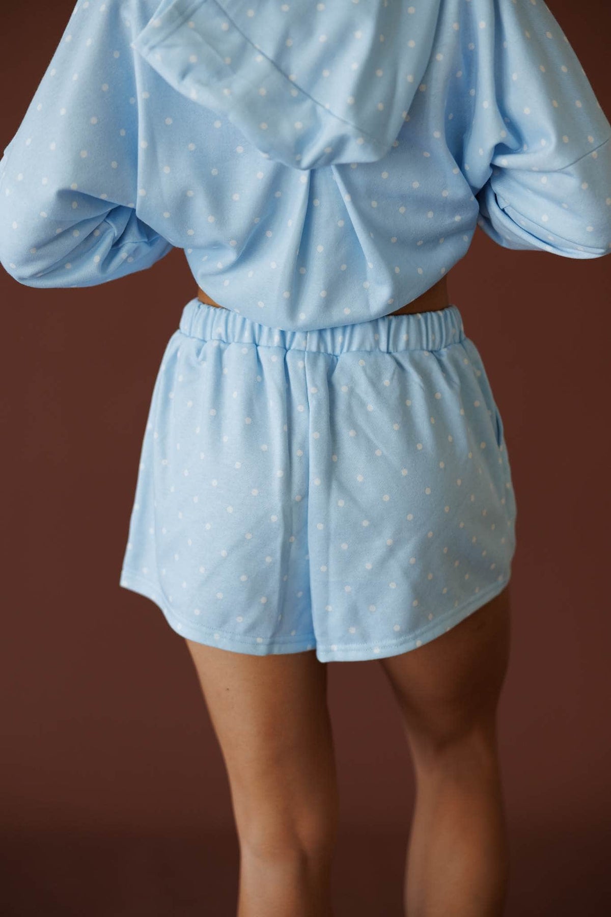 Baby Blue Polkadot Shorts in baby blue, back view showing the elastic waist and curved hem