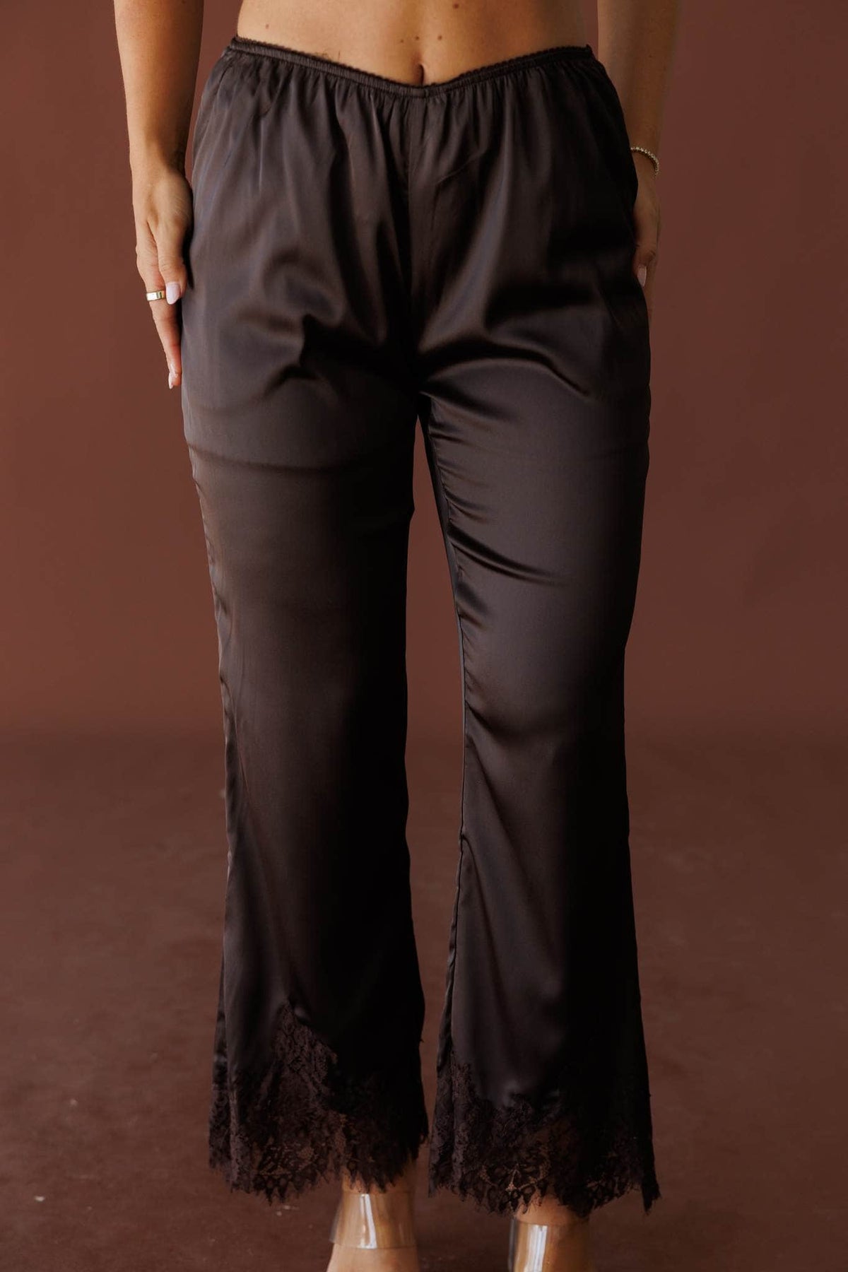 Dark brown satin pants with lace trim, front view