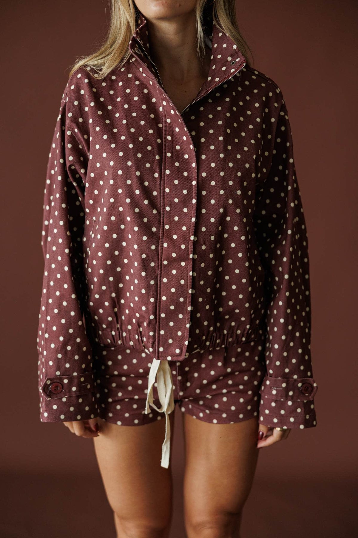 Cocoa Dot Lounge Jacket in hot chocolate, front close-up of the polka dot zip jacket
