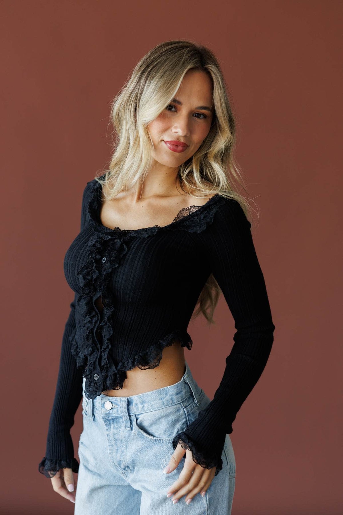 Colette Ruffle Top in black, front view on model with jeans