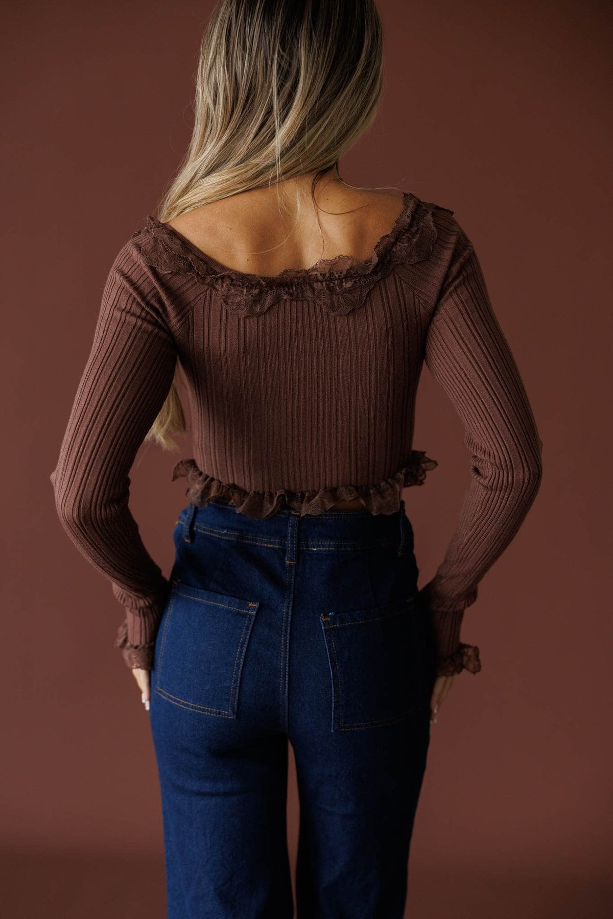 Colette Ruffle Top in mocha, back view showing the ribbed knit and ruffle hem