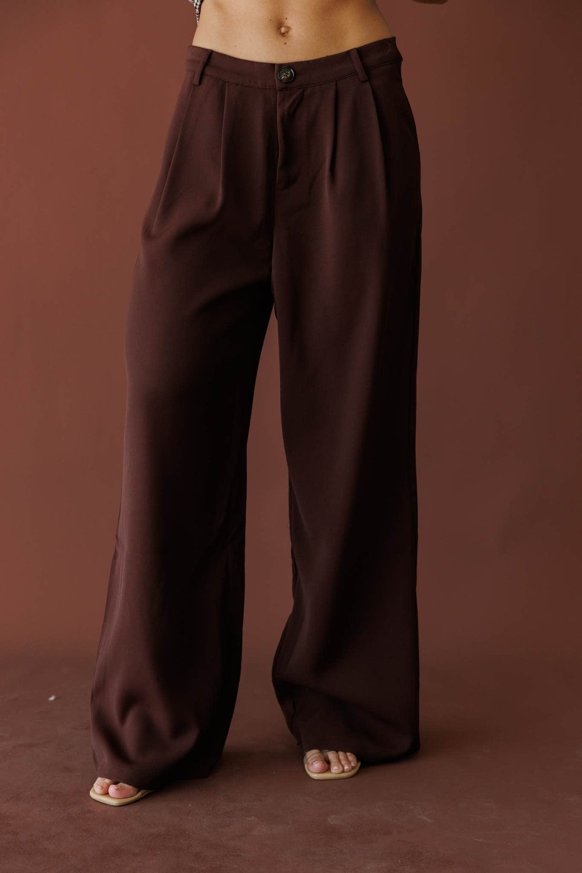 Dark brown pleated wide leg trousers, front view