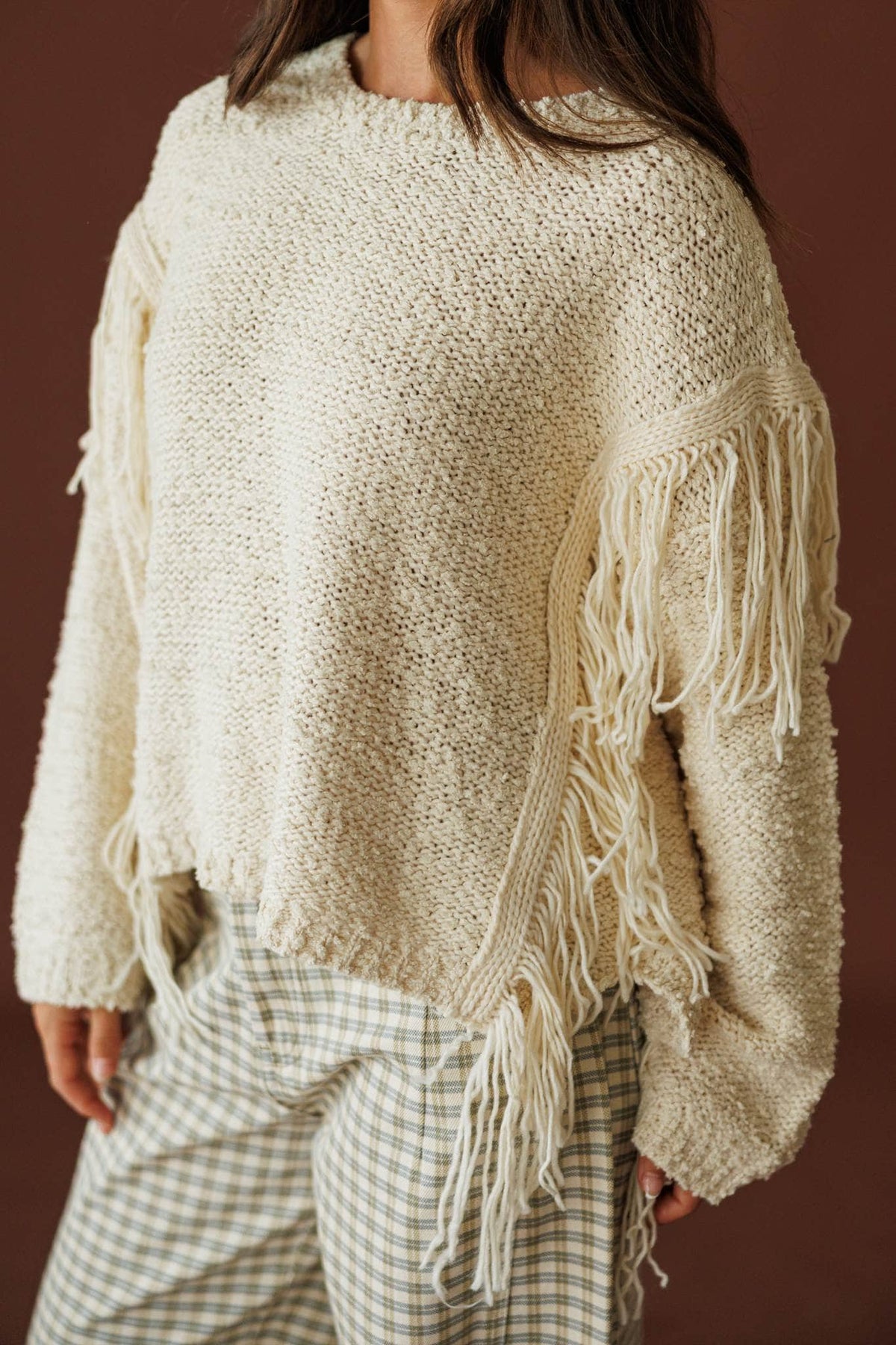 Cream Fringe Pullover Sweater, side view showing the fringe trim along the sleeve
