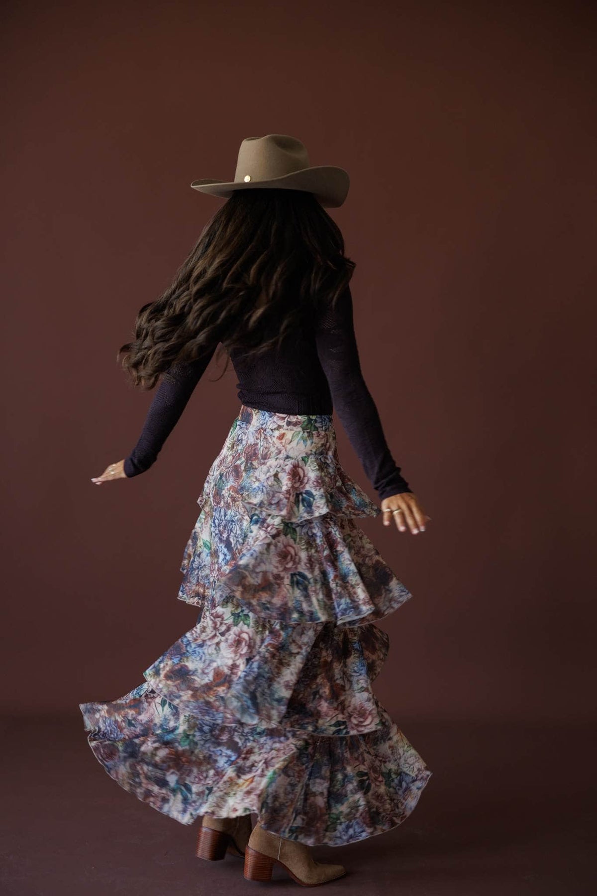 Falling Fast Floral Skirt in sand floral, back view on model turning with the skirt in motion