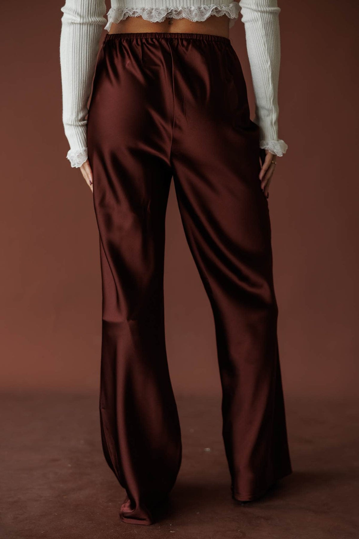 Nightcap Satin Trouser, in rum raisin, close front view of the waistband