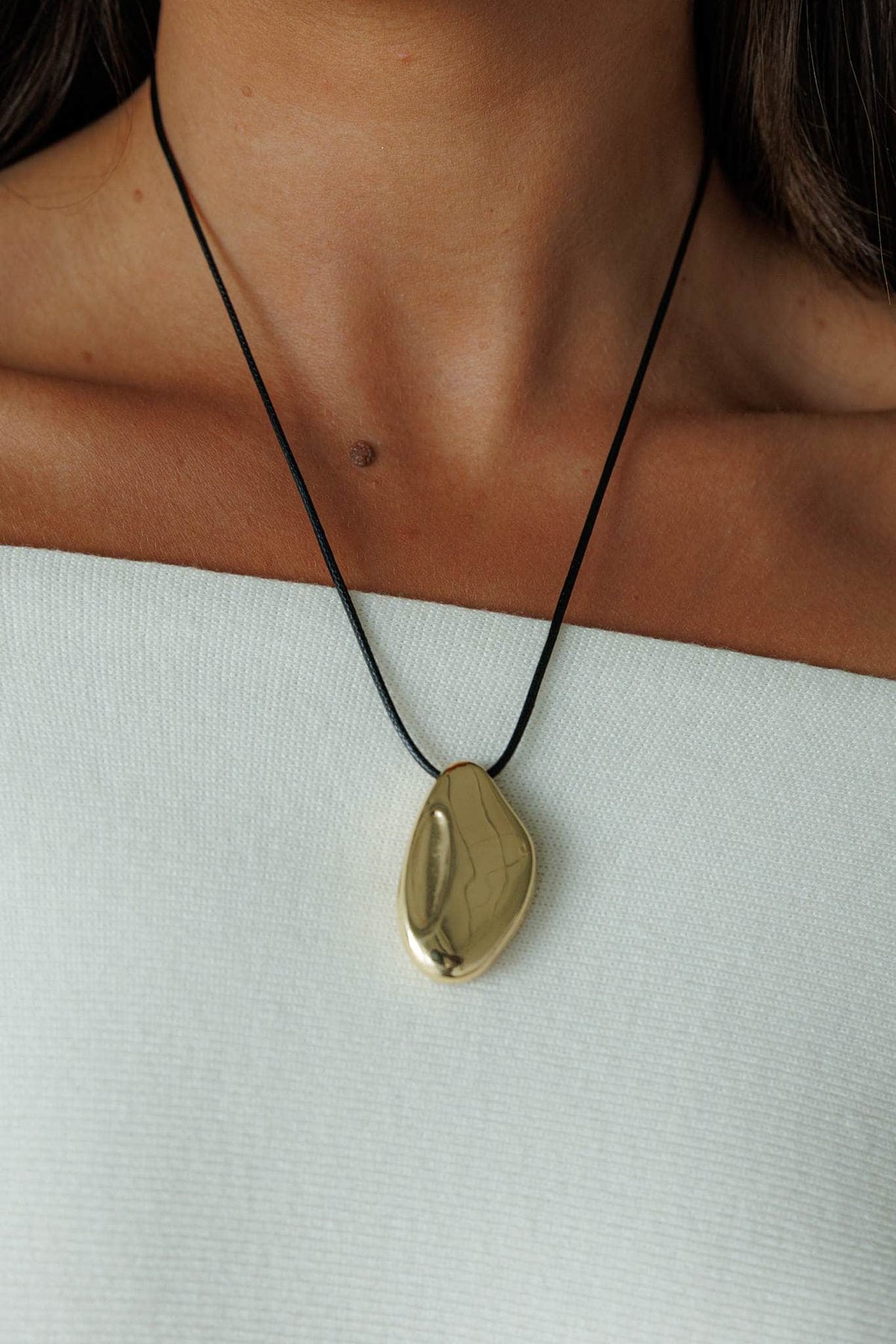 Gold Pendant Cord Necklace, worn at the neck on a fine black cord