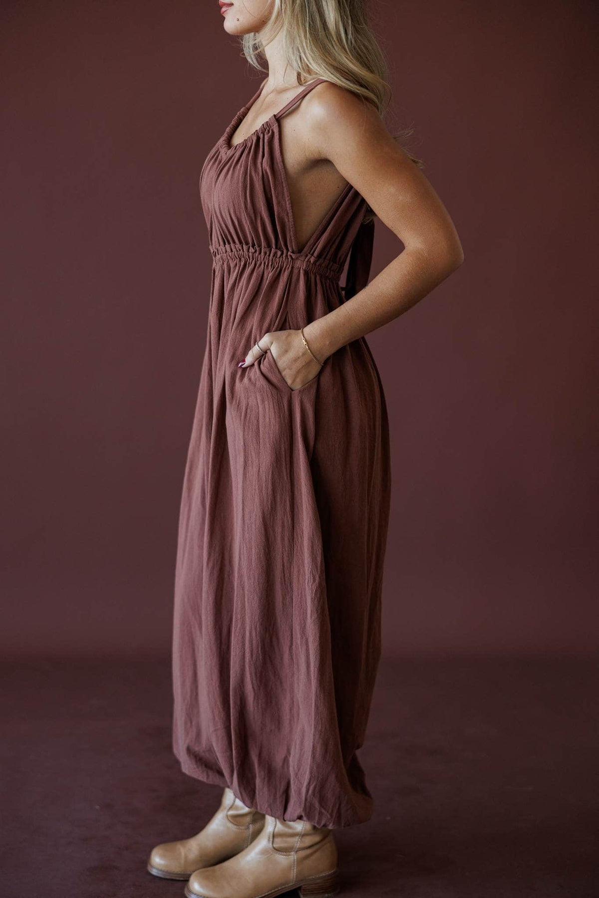 The Roam Jumpsuit, in brown, side view of the gathered waist