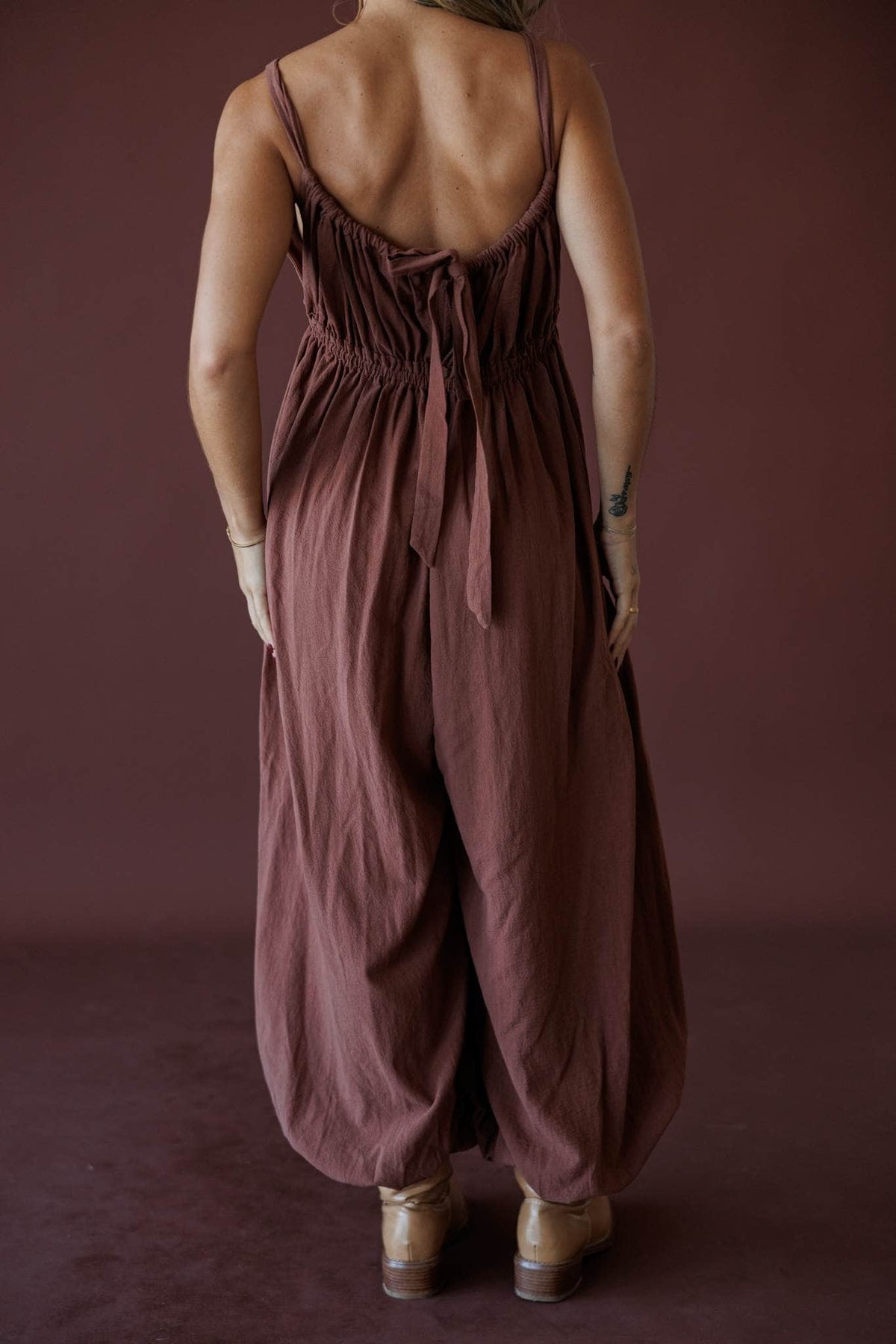 The Roam Jumpsuit, in brown, back view of the tie back