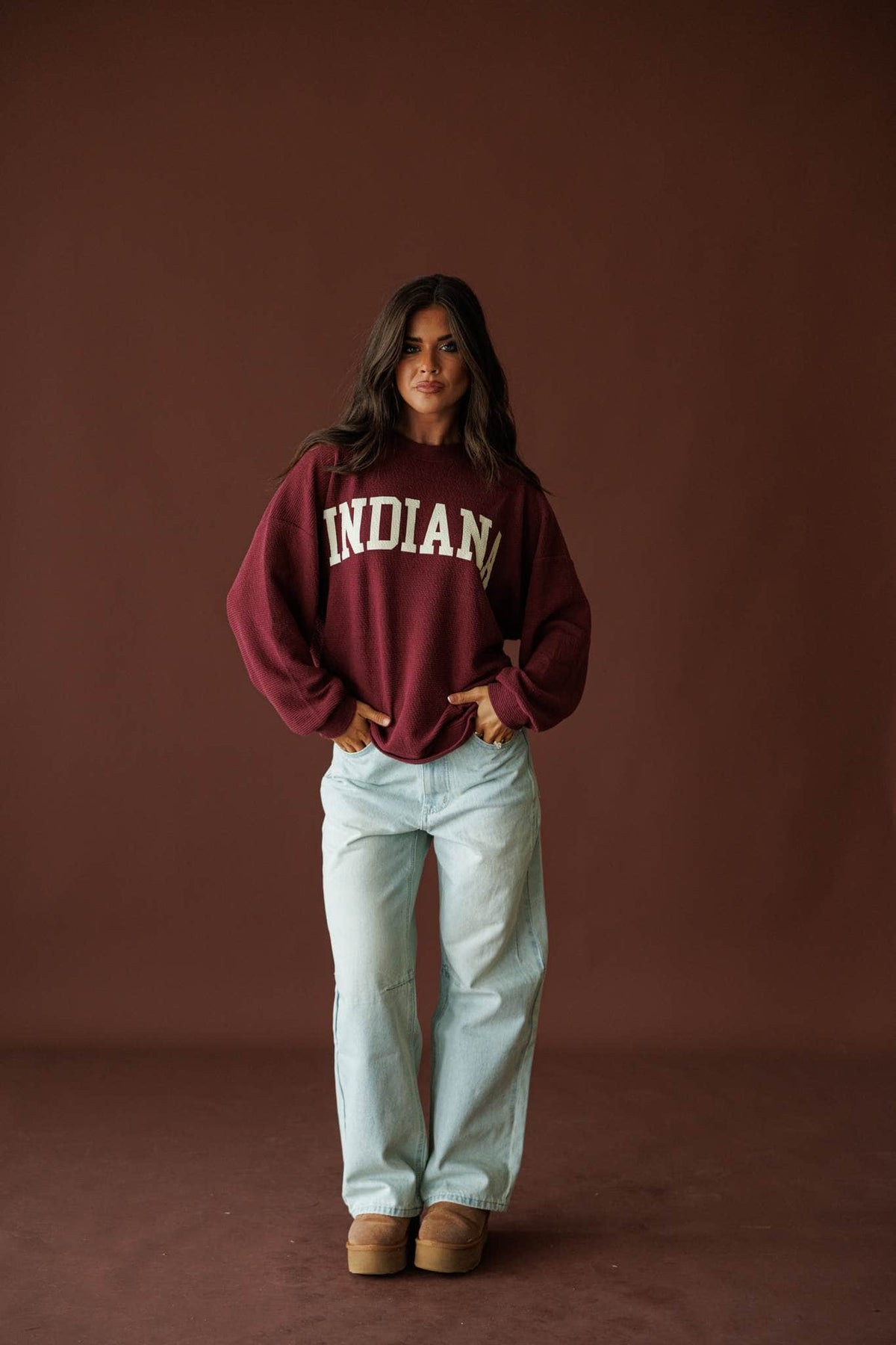 Indiana Cloud Knit Sweatshirt in wine, full-length view on model with a hand on the hip