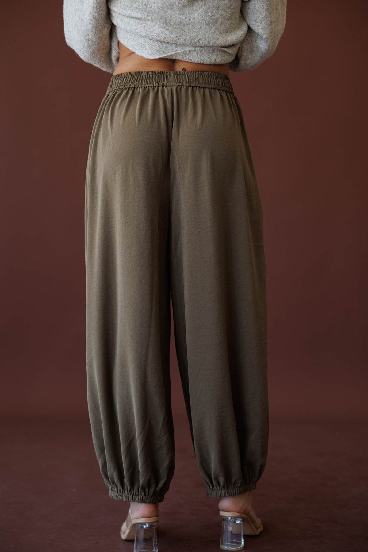 Olive Press Satin Pants, in khaki, side view of the fluid wide leg