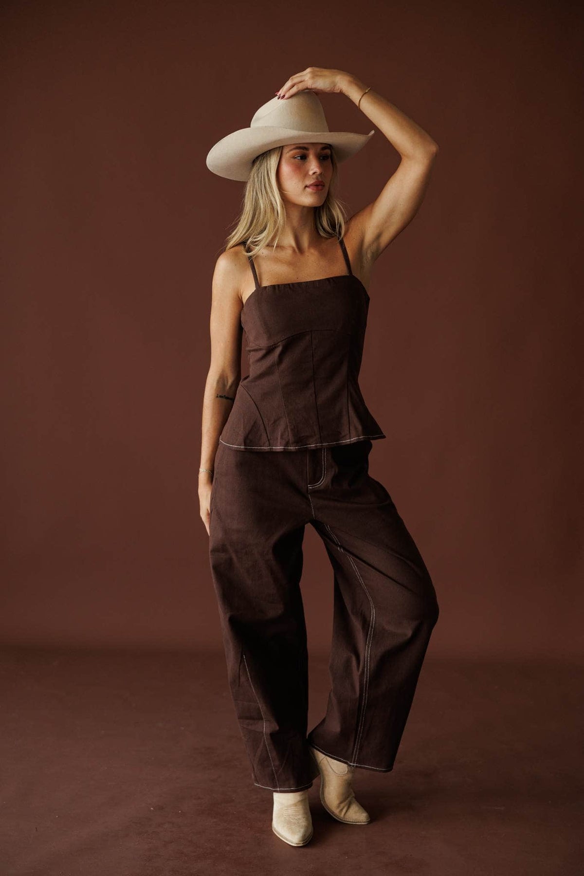 Roadhouse Barrel Pants in brown, full-length view with the matching peplum top and cowboy hat