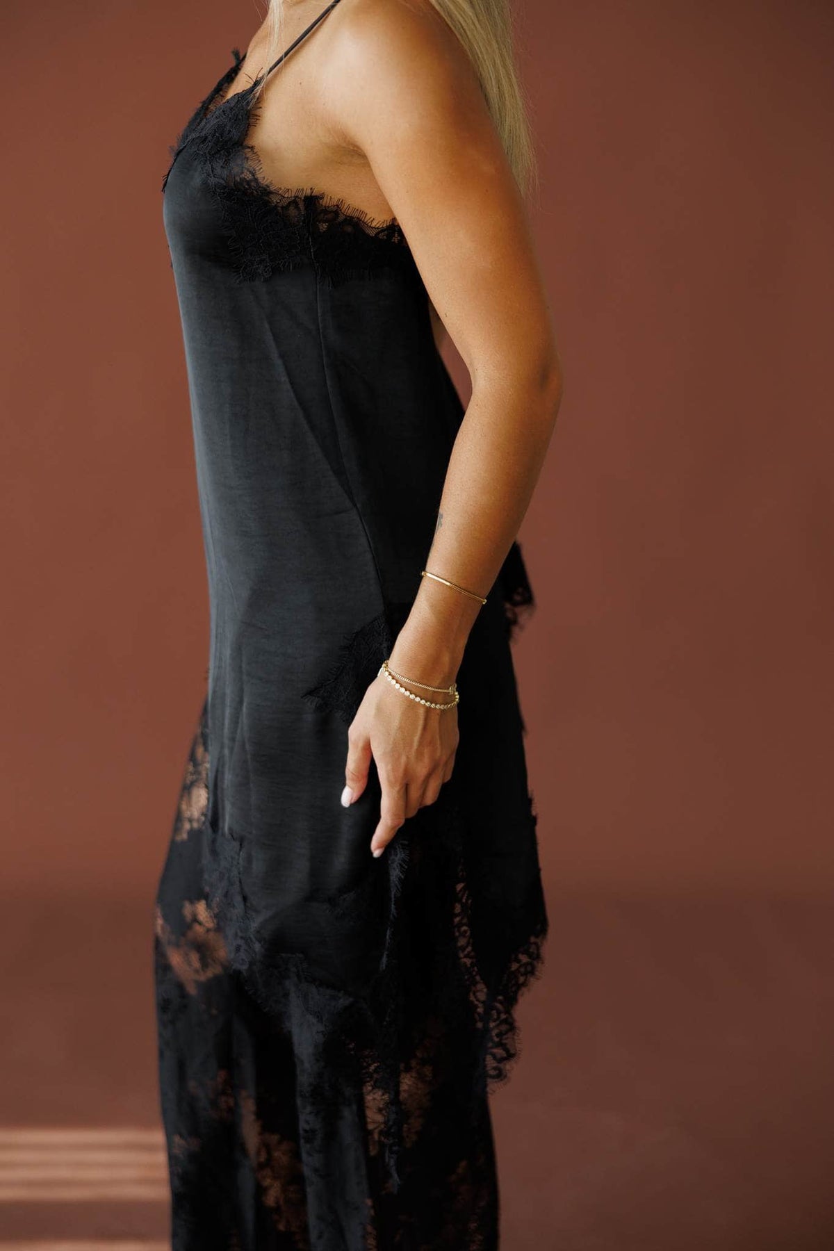 Love Letters Lace Top in black, front close-up of the asymmetric lace hem