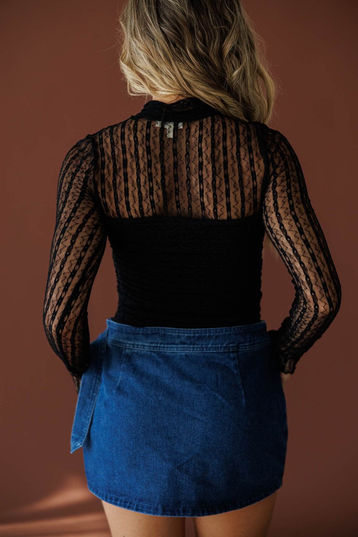 Lover In Lace Bodysuit in black, back view showing the sheer lace back