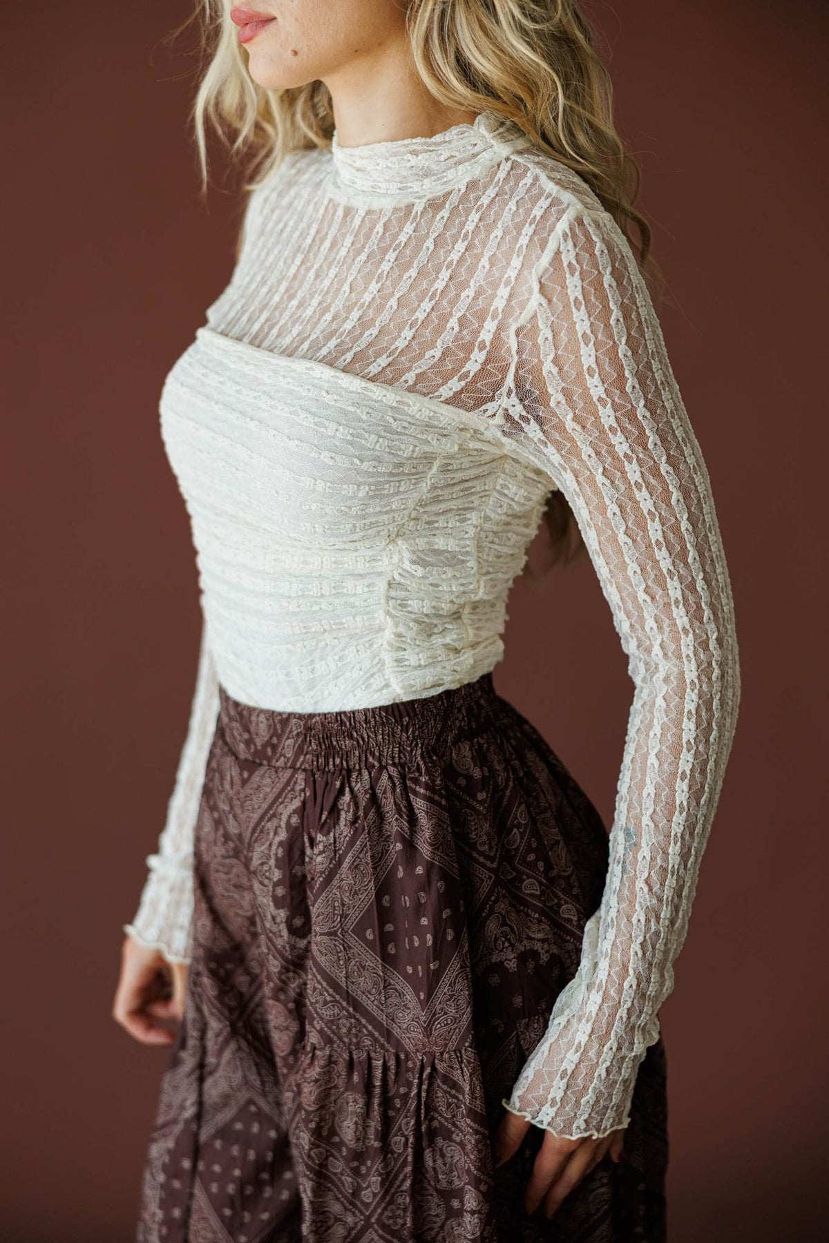 Lover In Lace Bodysuit in cream, side view showing the sheer lace sleeve