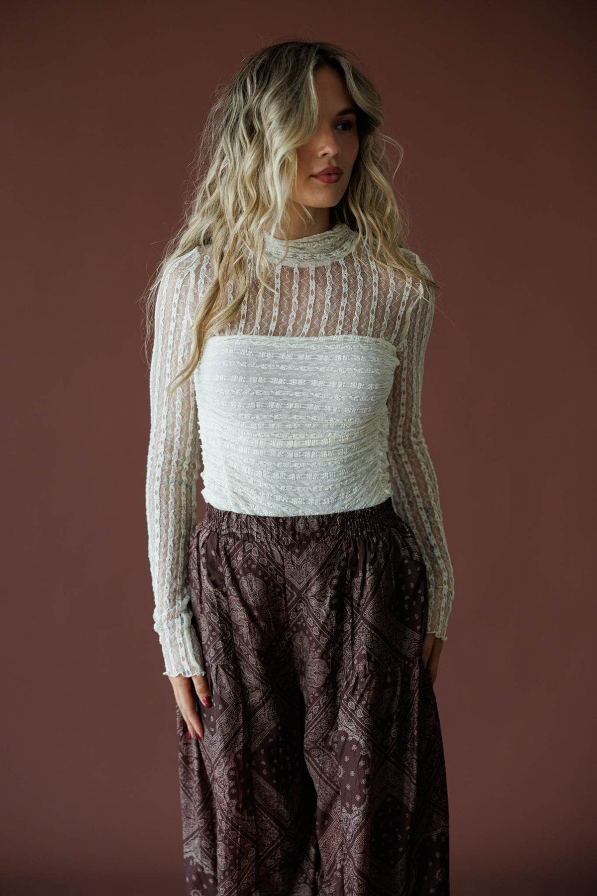 Lover In Lace Bodysuit in cream, full-length view with a brown printed maxi skirt