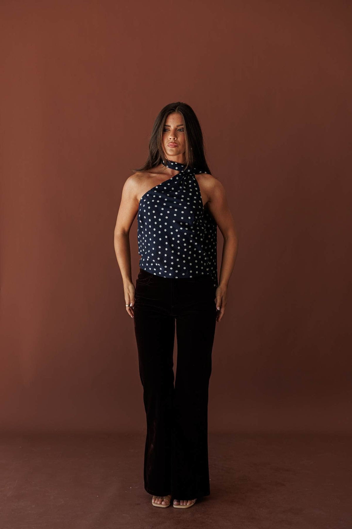 After Dark Velvet Flare Pants, in chocolate, full-length view with a polka dot halter top