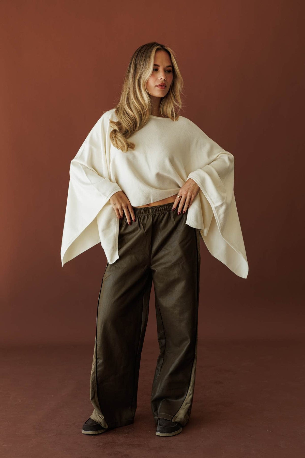 Expedition Suede Pants, in olive, three-quarter view with a cream top