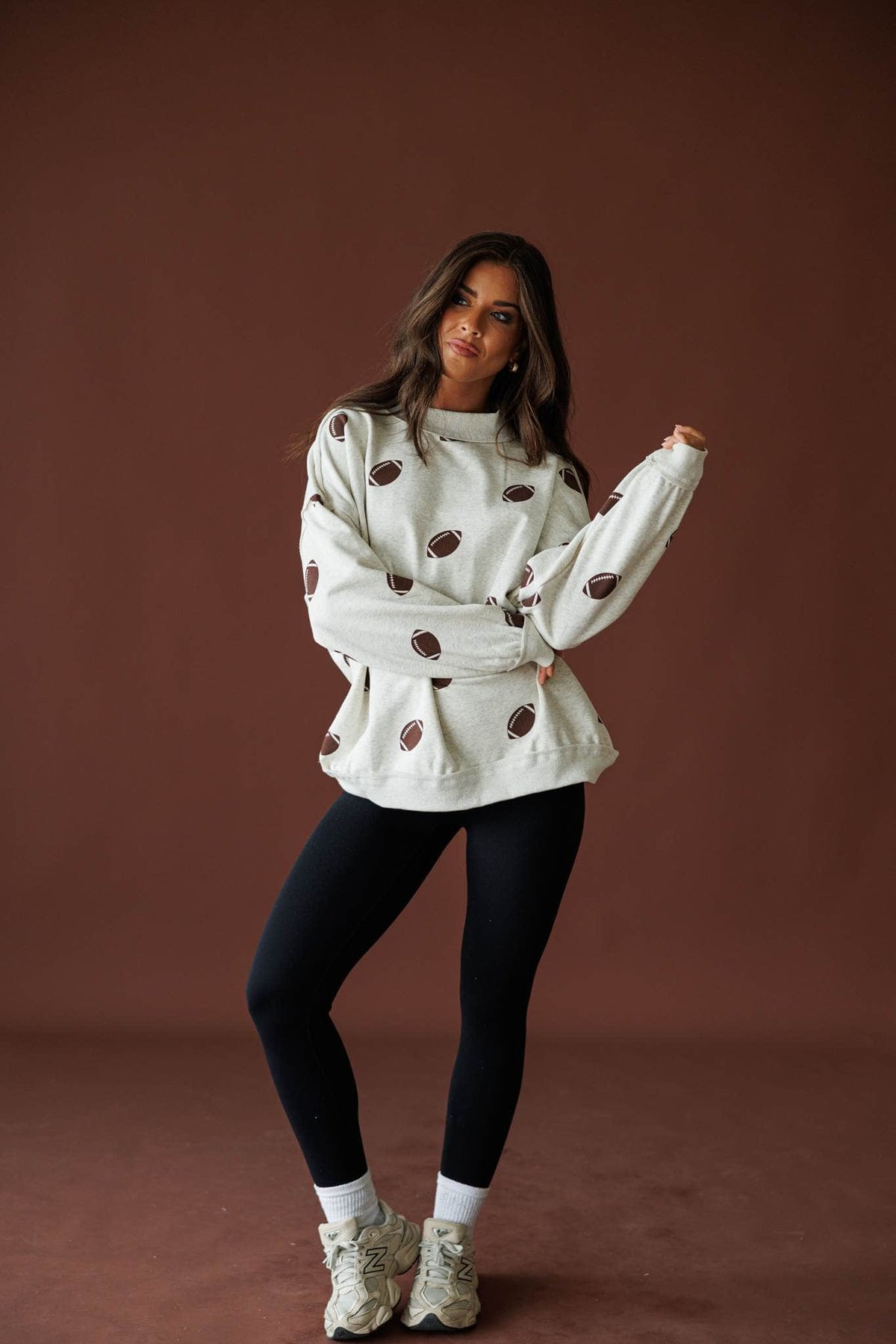Butter Soft Seamless Leggings in black, full-length view with a cream floral sweater