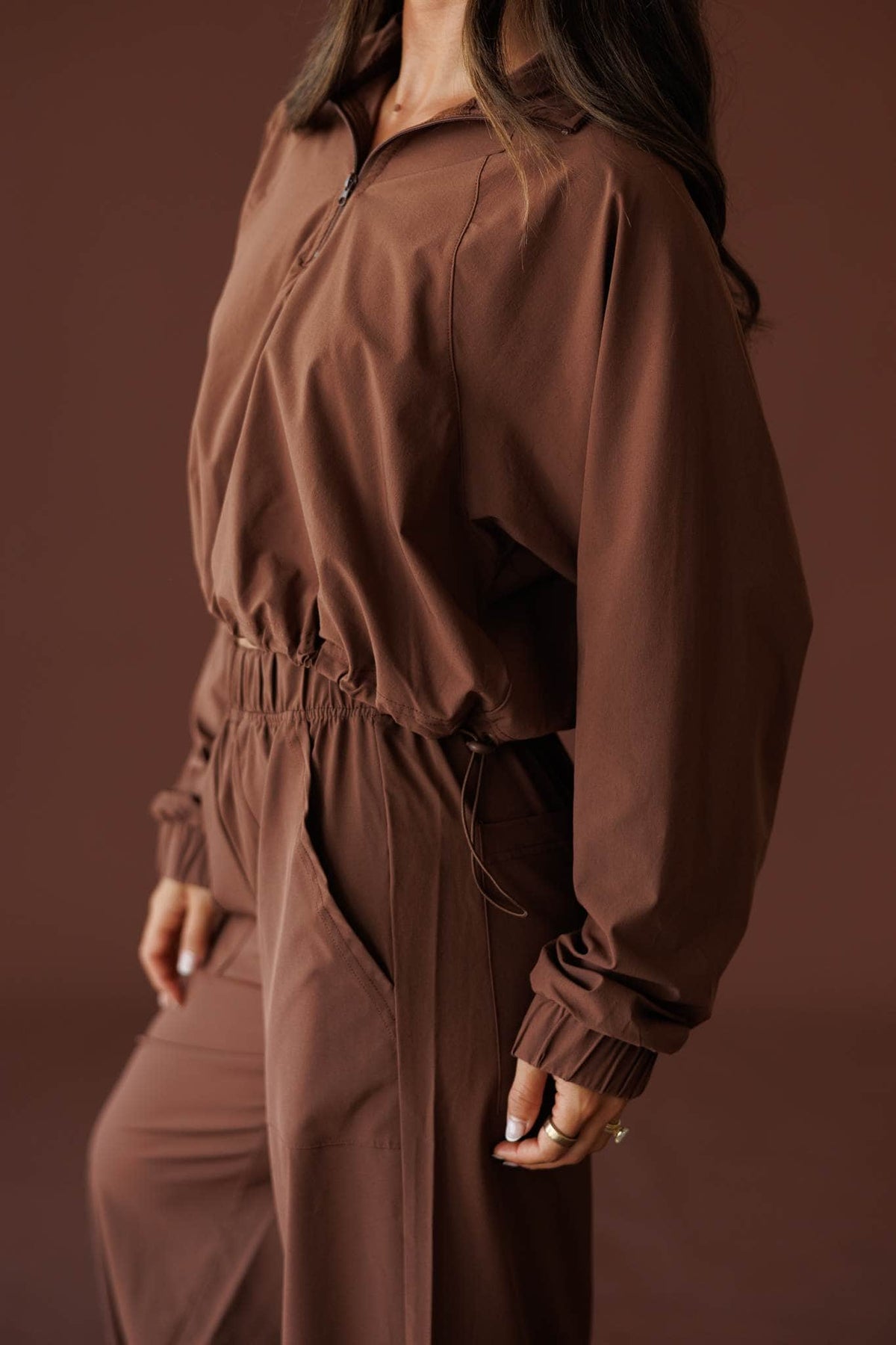 Pace Yourself Half Zip Pullover in cocoa, side view showing the elastic hem and cuff