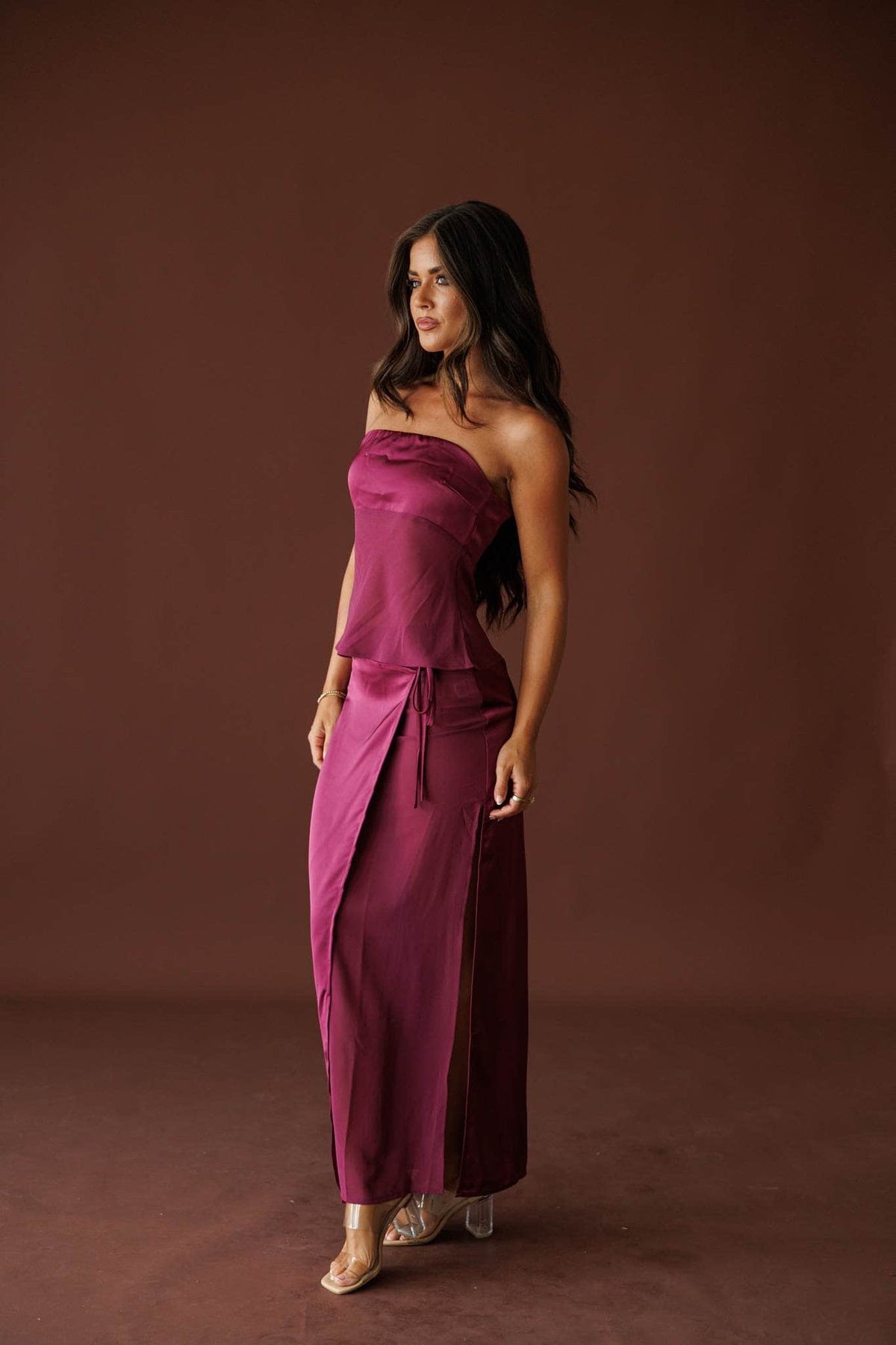 Plum Hour Satin Maxi Skirt in plum, side view showing the wrap front and side slit