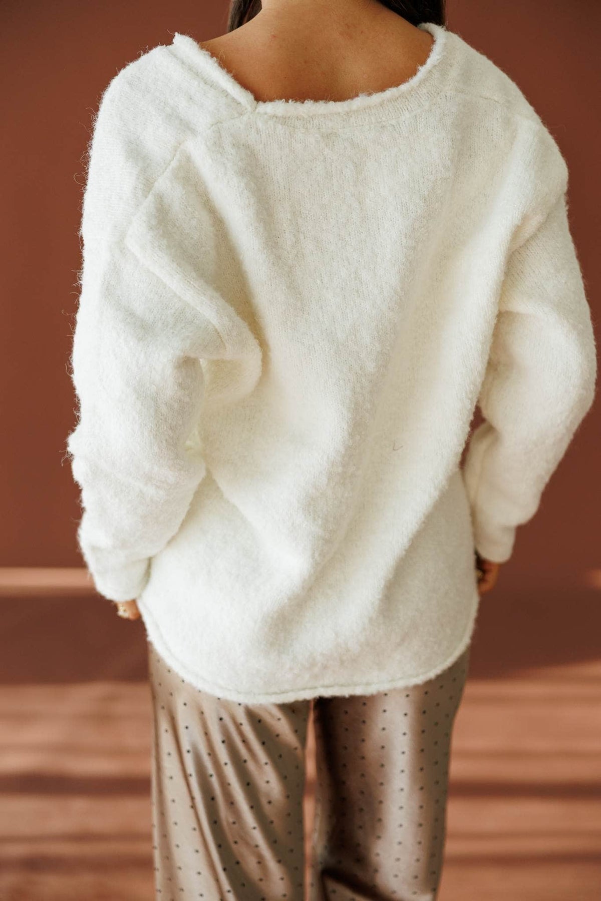 Half Past Cozy Sweater in ivory, back view showing the scoop back and curved hem