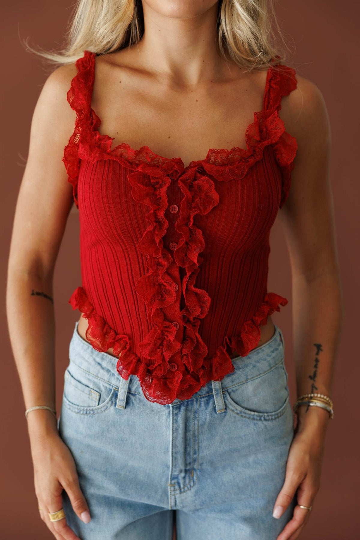 Pretty Little Secret Top in pomegranate, front close-up of the ruffle trimmed knit