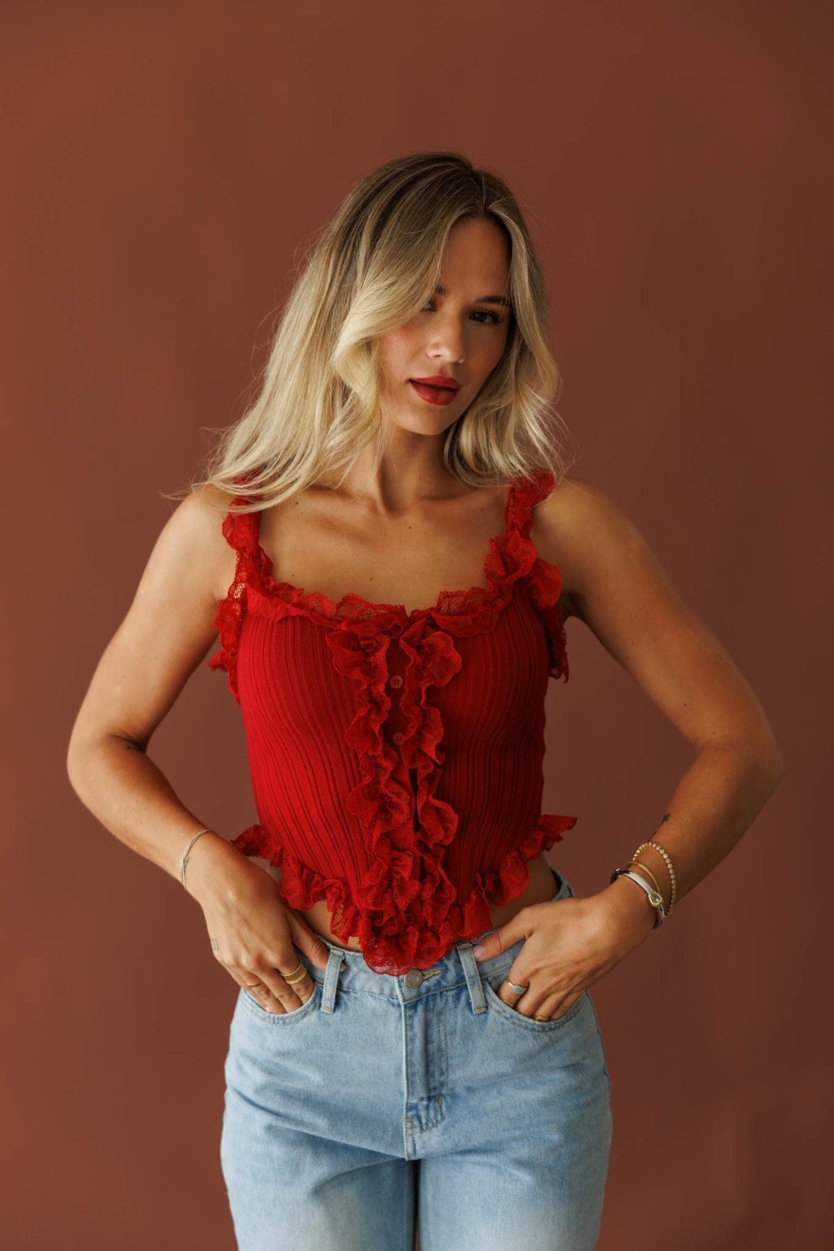 Pretty Little Secret Top in pomegranate, front view on model with light wash jeans