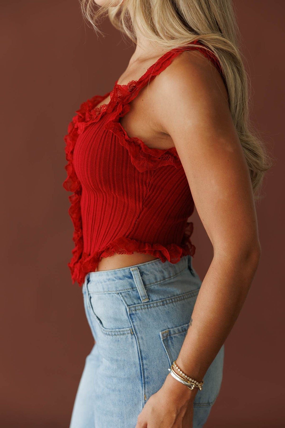 Pretty Little Secret Top in pomegranate, side view showing the cropped ruffle hem