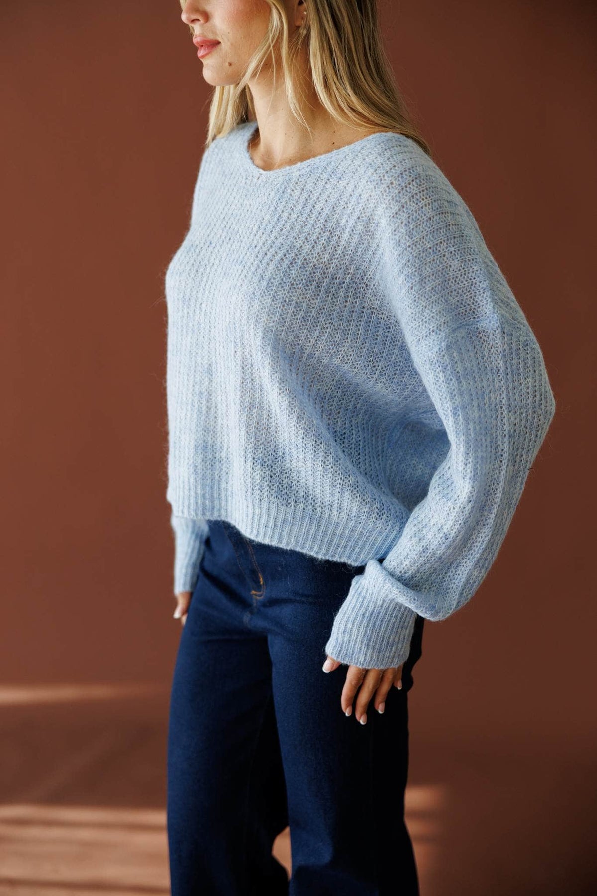 Repeat Staple Sweater in light blue, side view showing the balloon sleeve knit