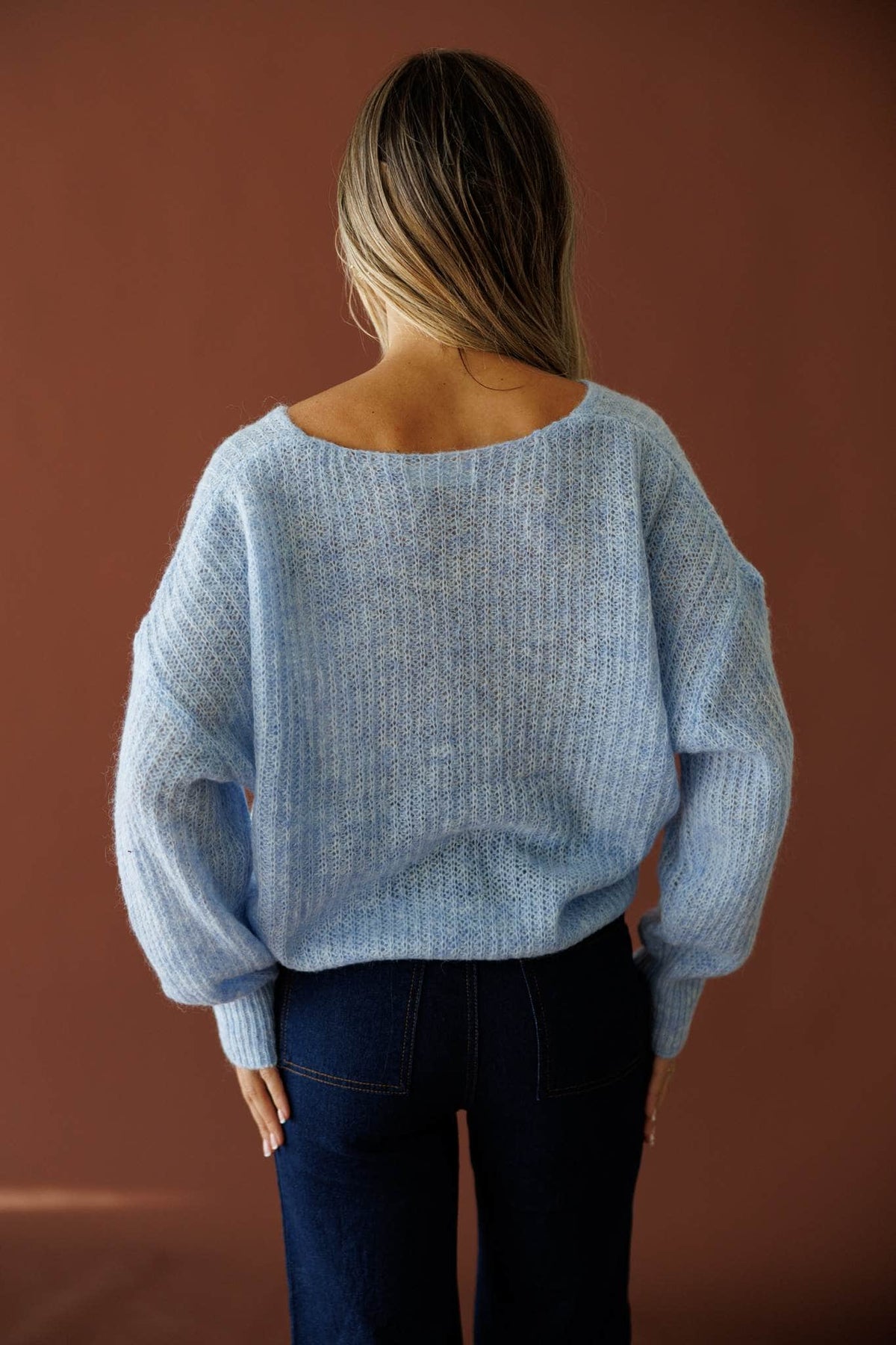 Repeat Staple Sweater in light blue, back view showing the scoop back knit sweater