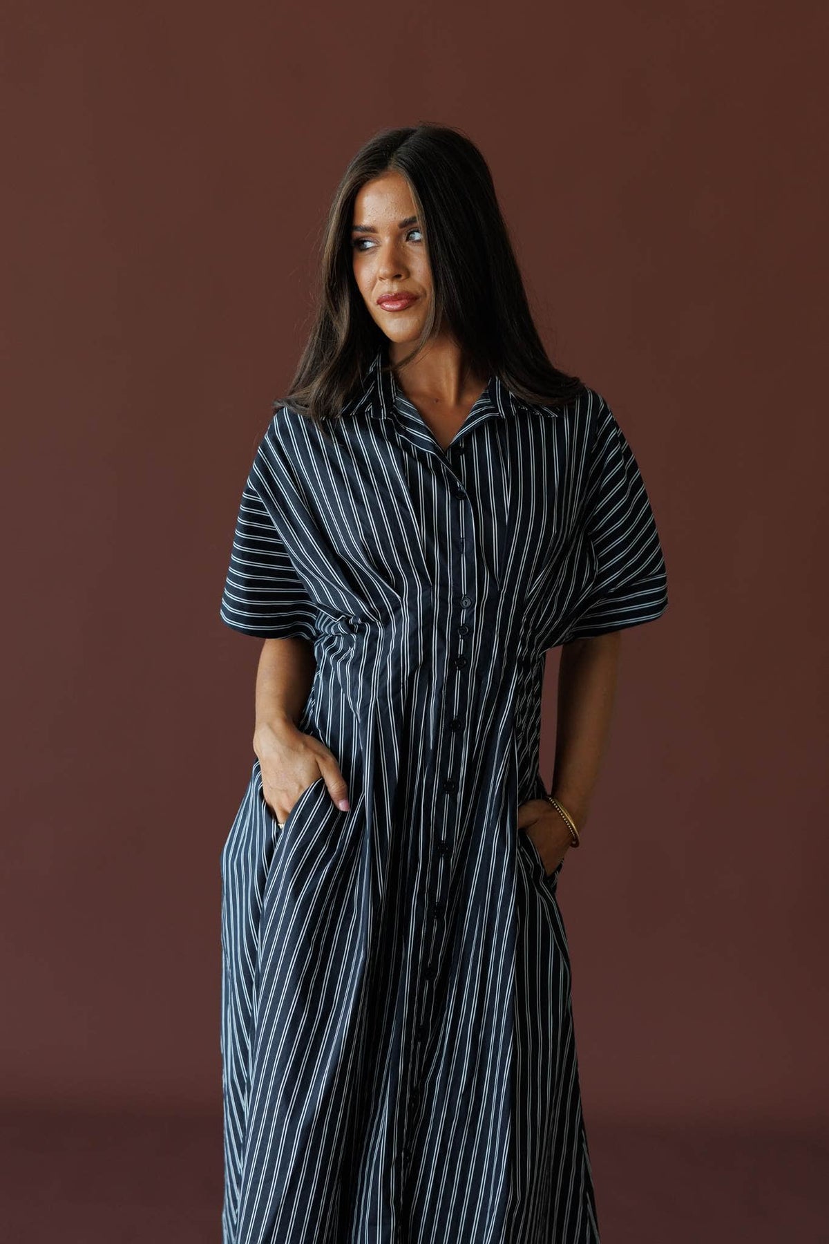 Striped Dolman Sleeve Midi Dress in black stripe, front view on model with hands in pockets